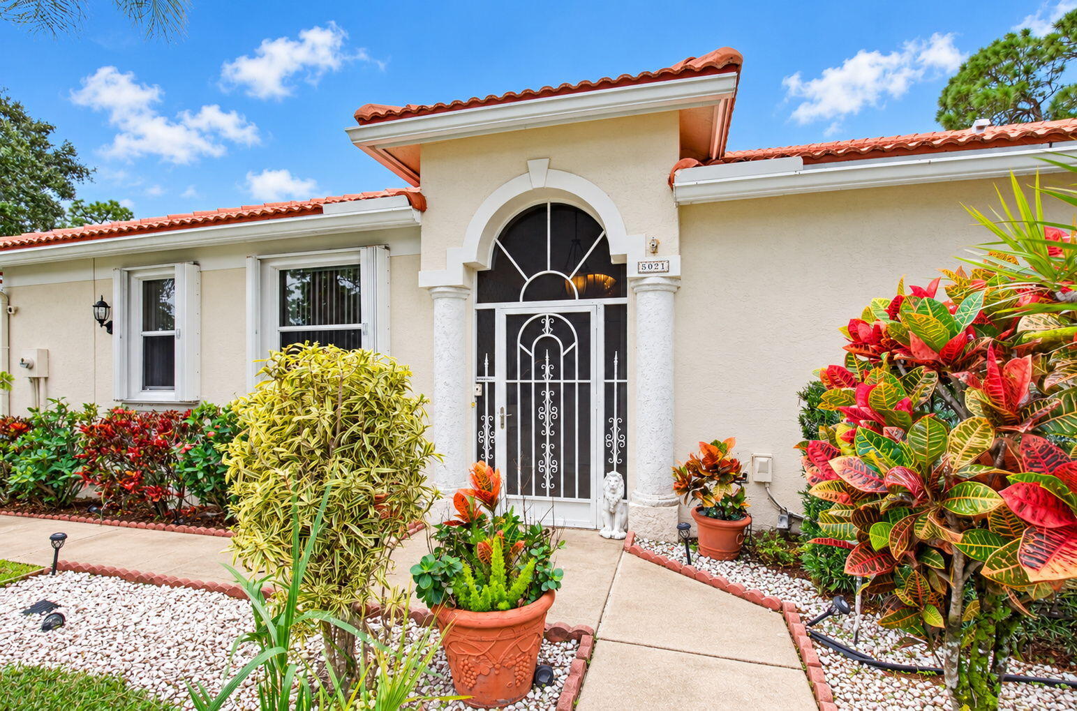 Beautifully Landscaped Entrance with Decorative Ironwork Beautifully Landscaped Entrance with Decorative Ironwork
