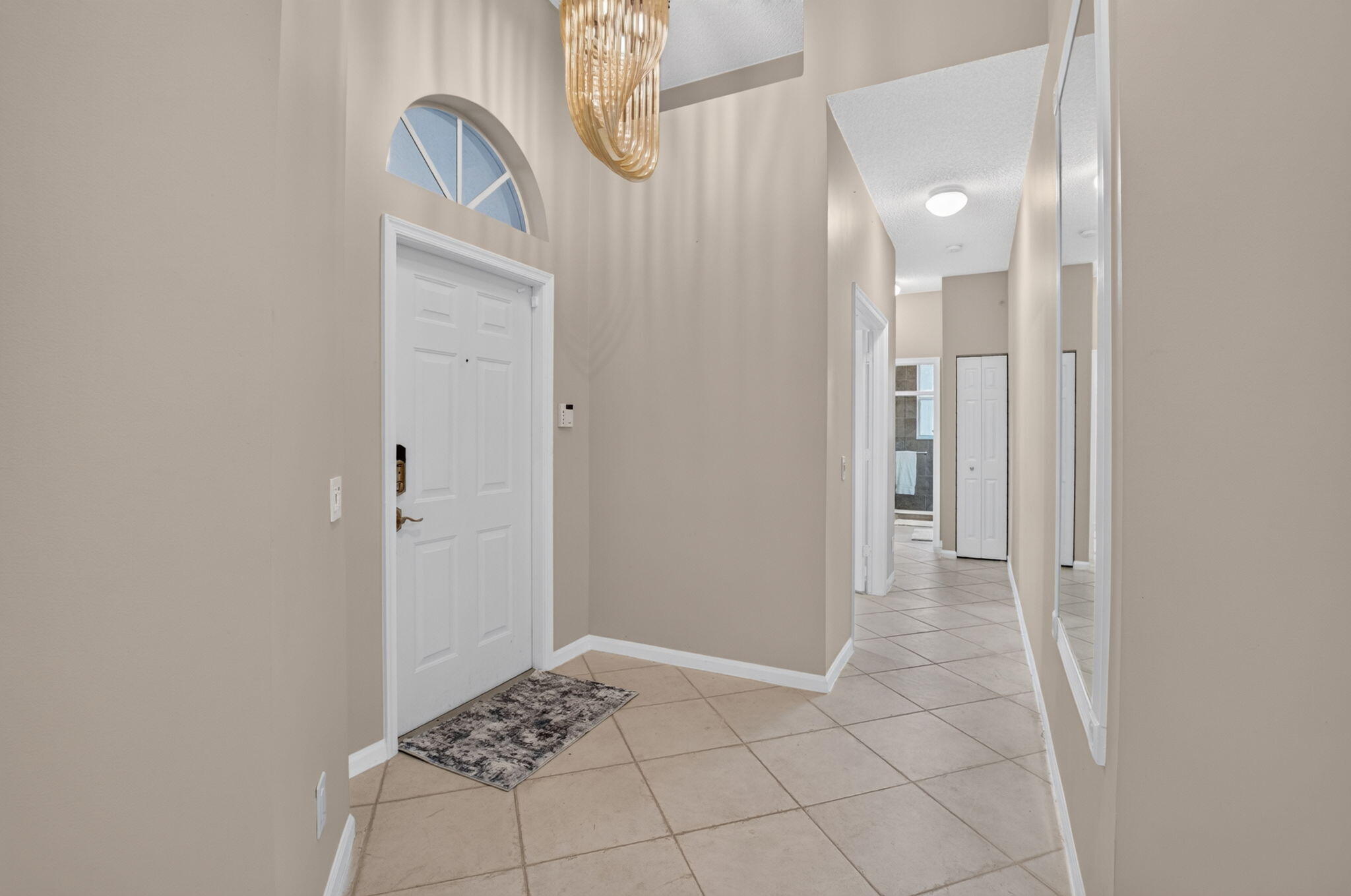 Welcoming Foyer with Elegant Lighting & High Ceilings