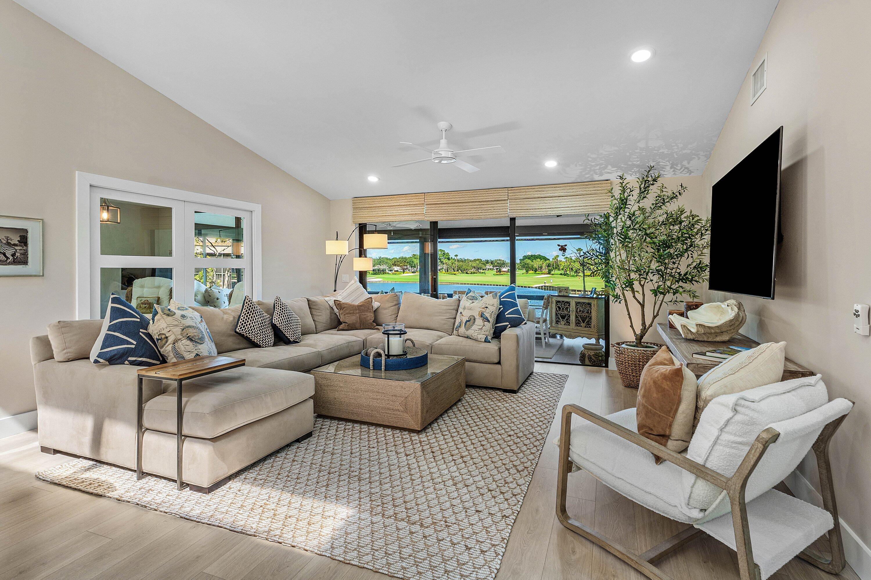 Vaulted ceilings, wood-finish flooring, recessed lighting, ceiling fan, and sliding glass doors Vaulted ceilings, wood-finish flooring, recessed lighting, ceiling fan, and sliding glass doors