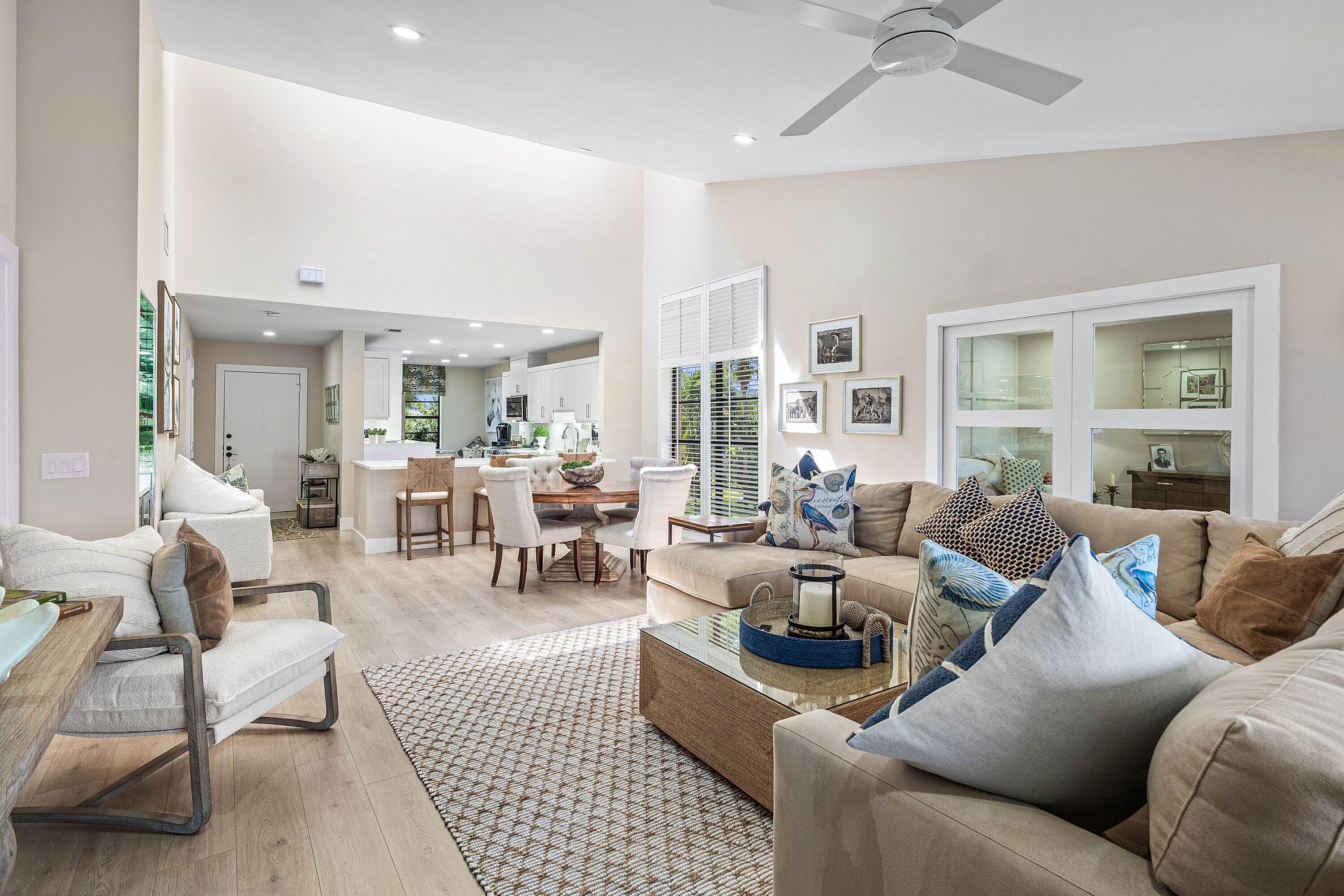Vaulted ceilings with recessed lighting, wood-finish flooring, and a ceiling fan Vaulted ceilings with recessed lighting, wood-finish flooring, and a ceiling fan