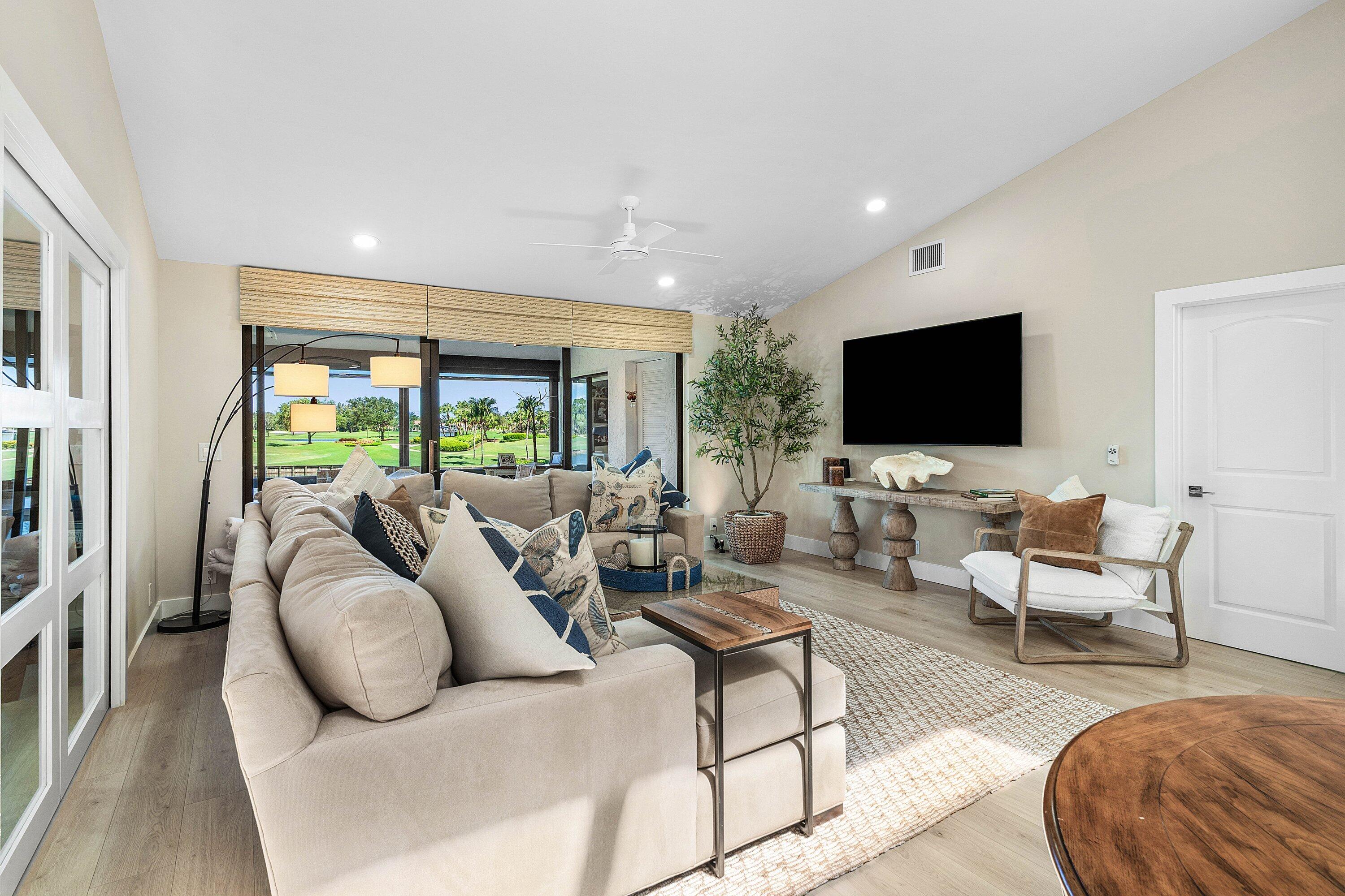 Vaulted ceilings, wood-finish flooring, recessed lighting, ceiling fan, and sliding glass doors Vaulted ceilings, wood-finish flooring, recessed lighting, ceiling fan, and sliding glass doors