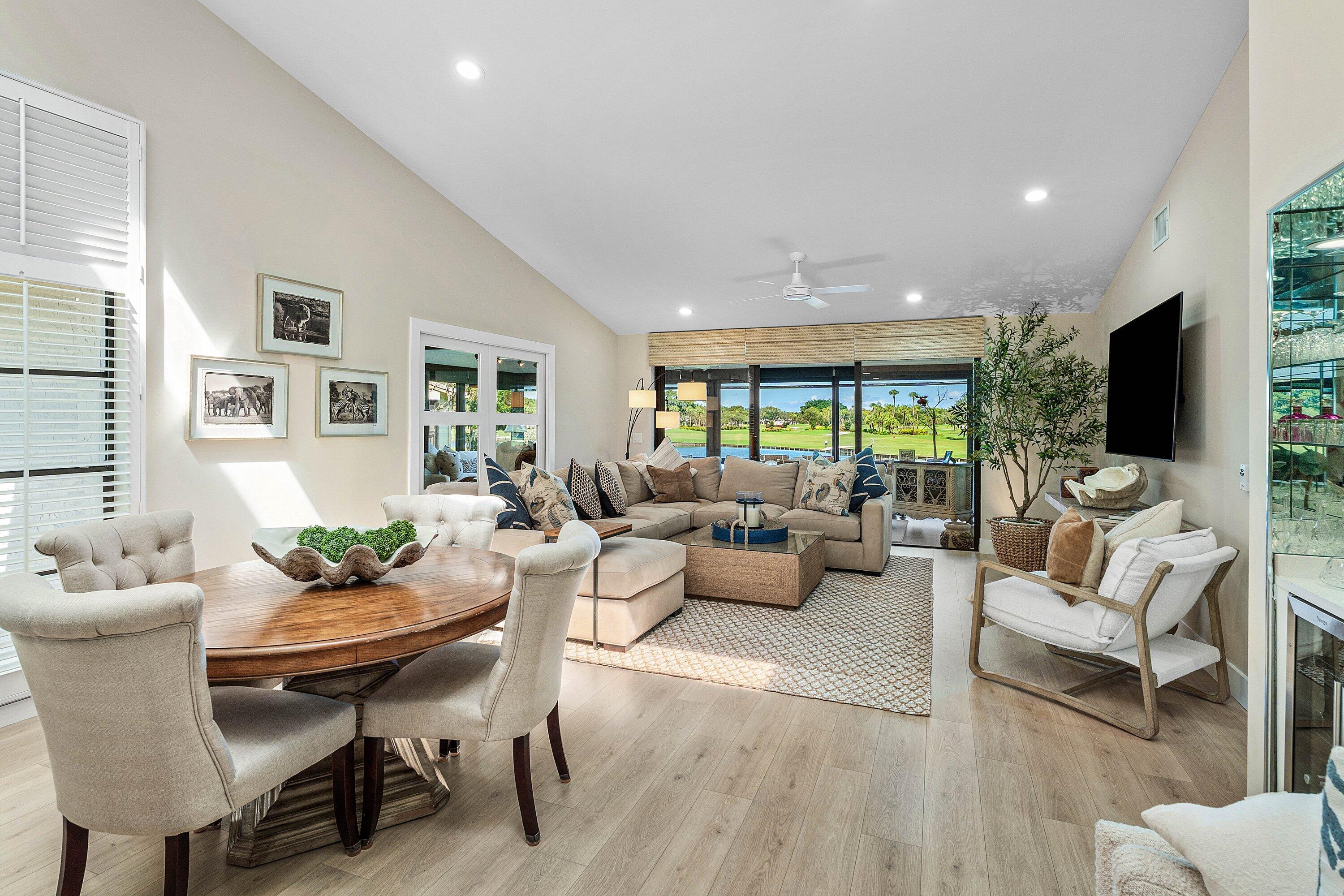 Vaulted ceilings, wood-finish flooring, recessed lighting, and expansive sliding glass doors Vaulted ceilings, wood-finish flooring, recessed lighting, and expansive sliding glass doors