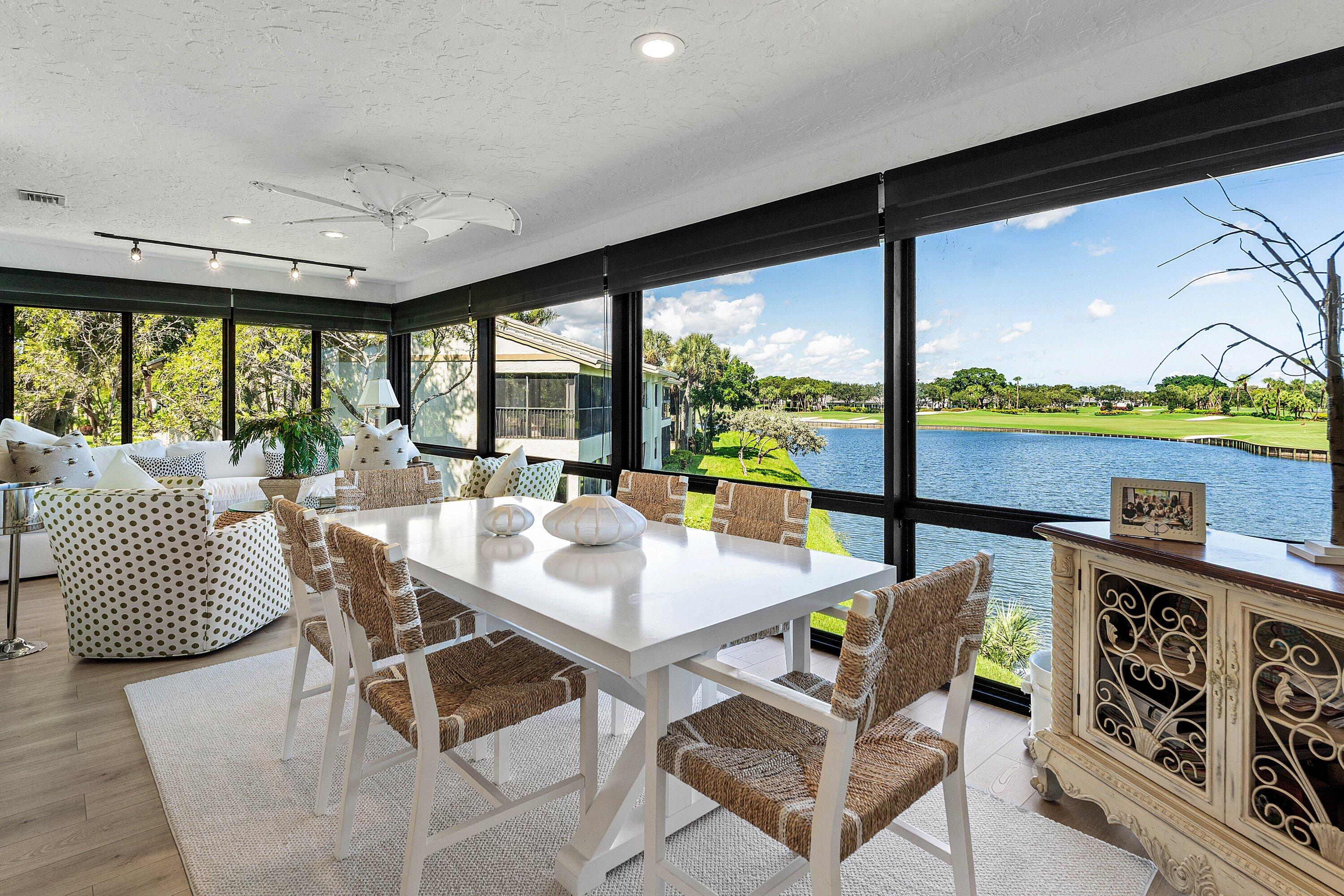 Enclosed sunroom featuring floor-to-ceiling windows, wood-finish flooring, recessed lighting, and track lighting