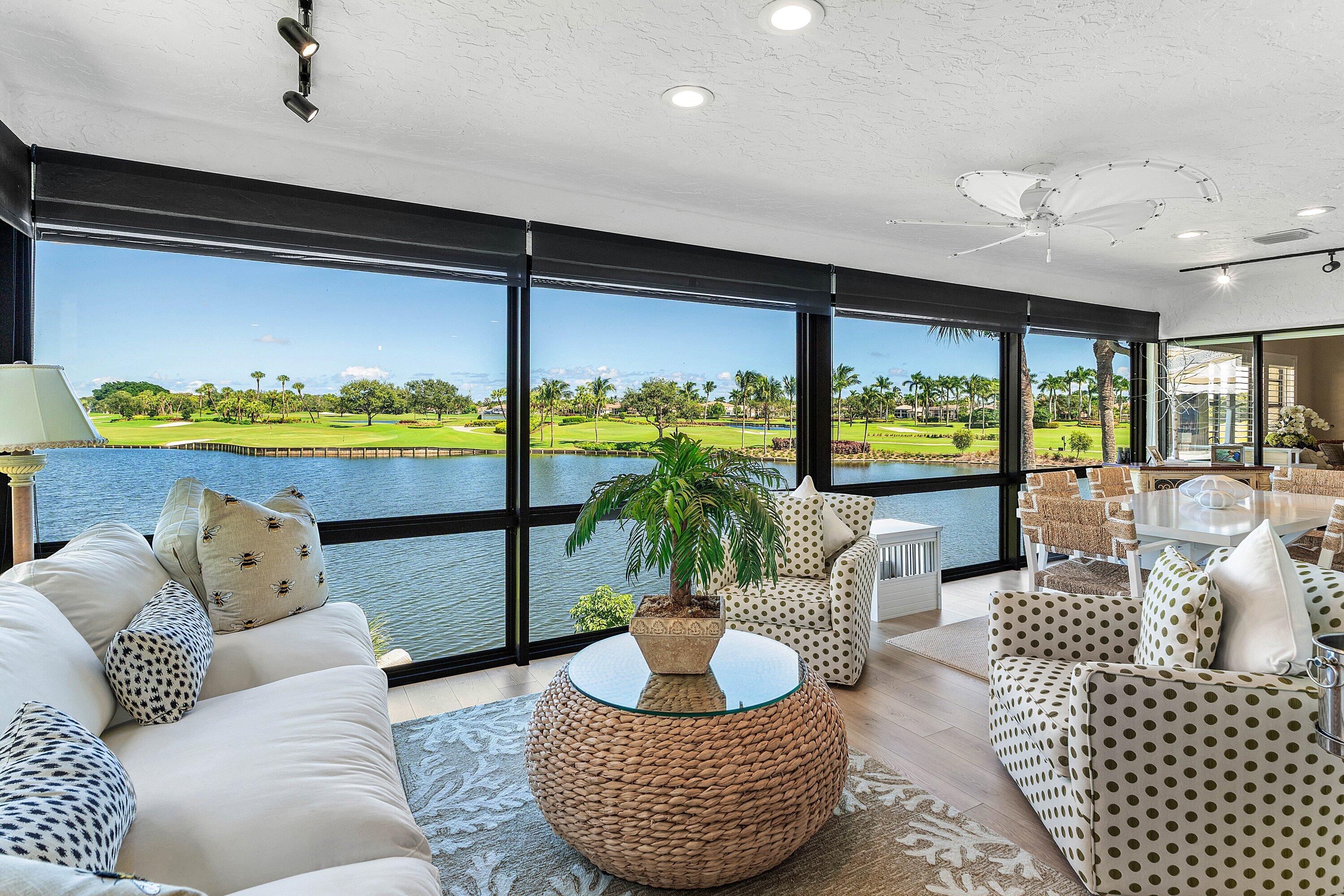 Enclosed porch featuring expansive floor-to-ceiling windows, wood-finish flooring, recessed lighting, and a ceiling fan