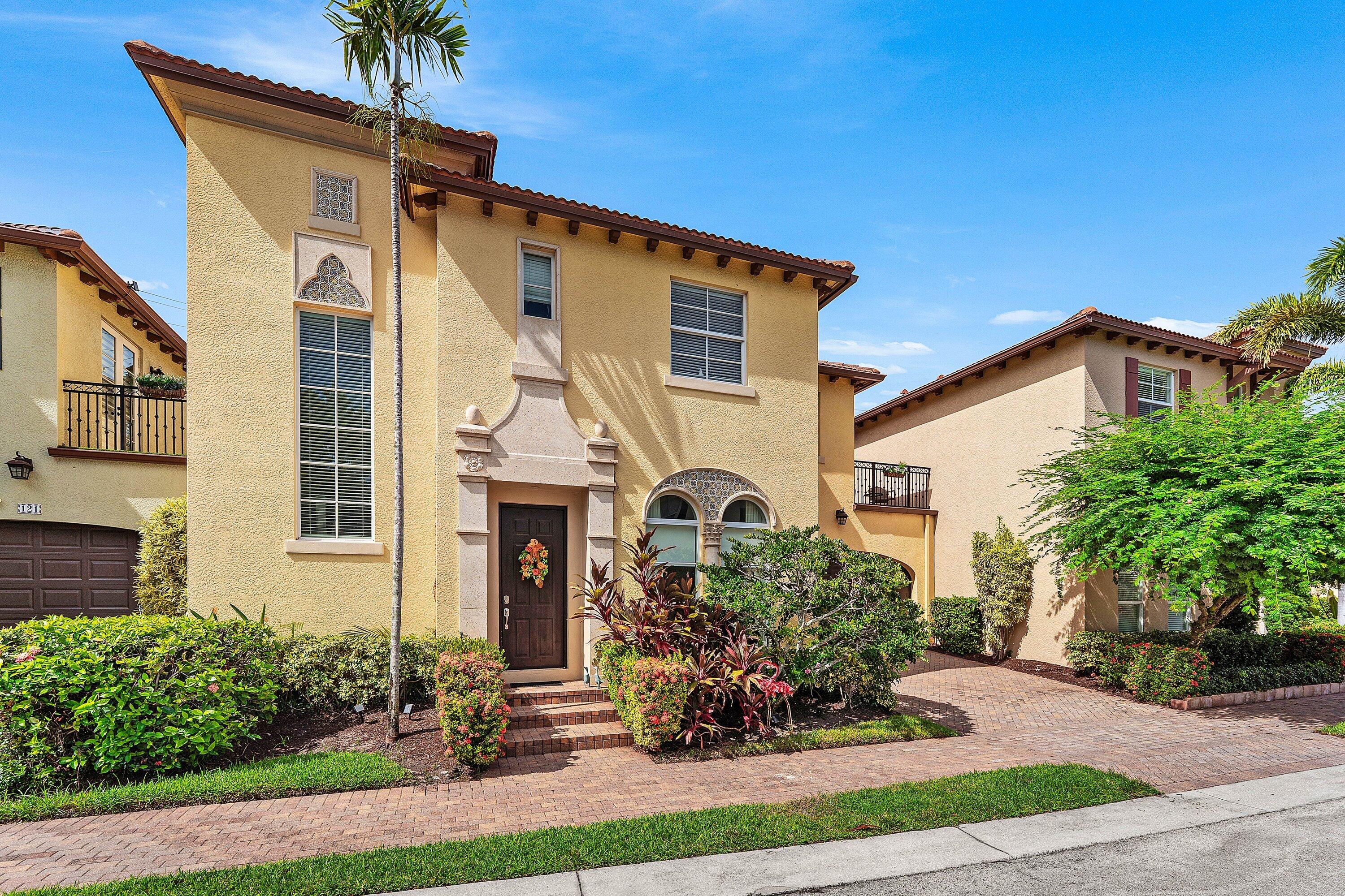 Side-angle view showcasing the homes distinctive architectural details, mature landscaping, and charming curb appeal