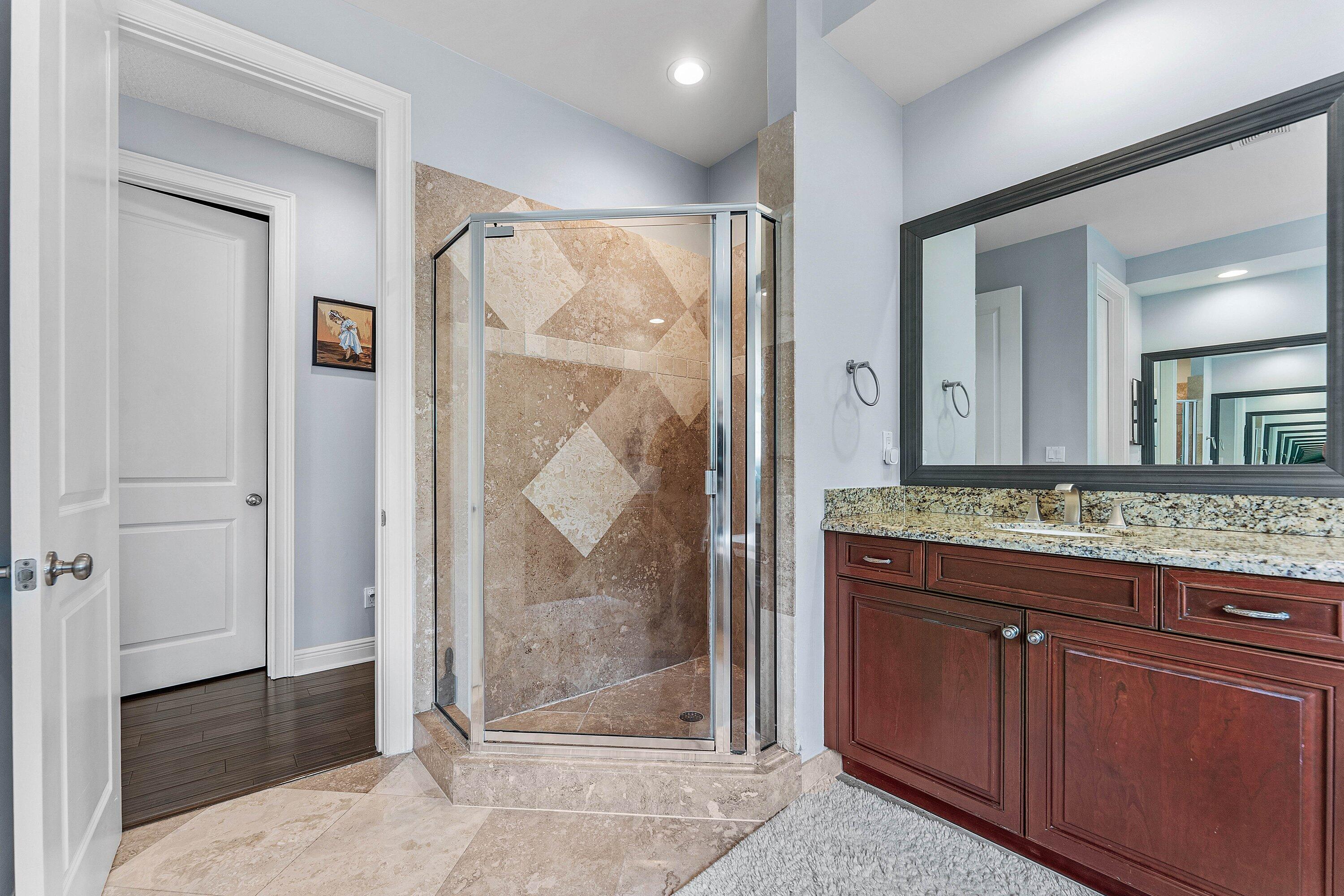 Spa-like master bathroom with dual vanity and walk-in shower.