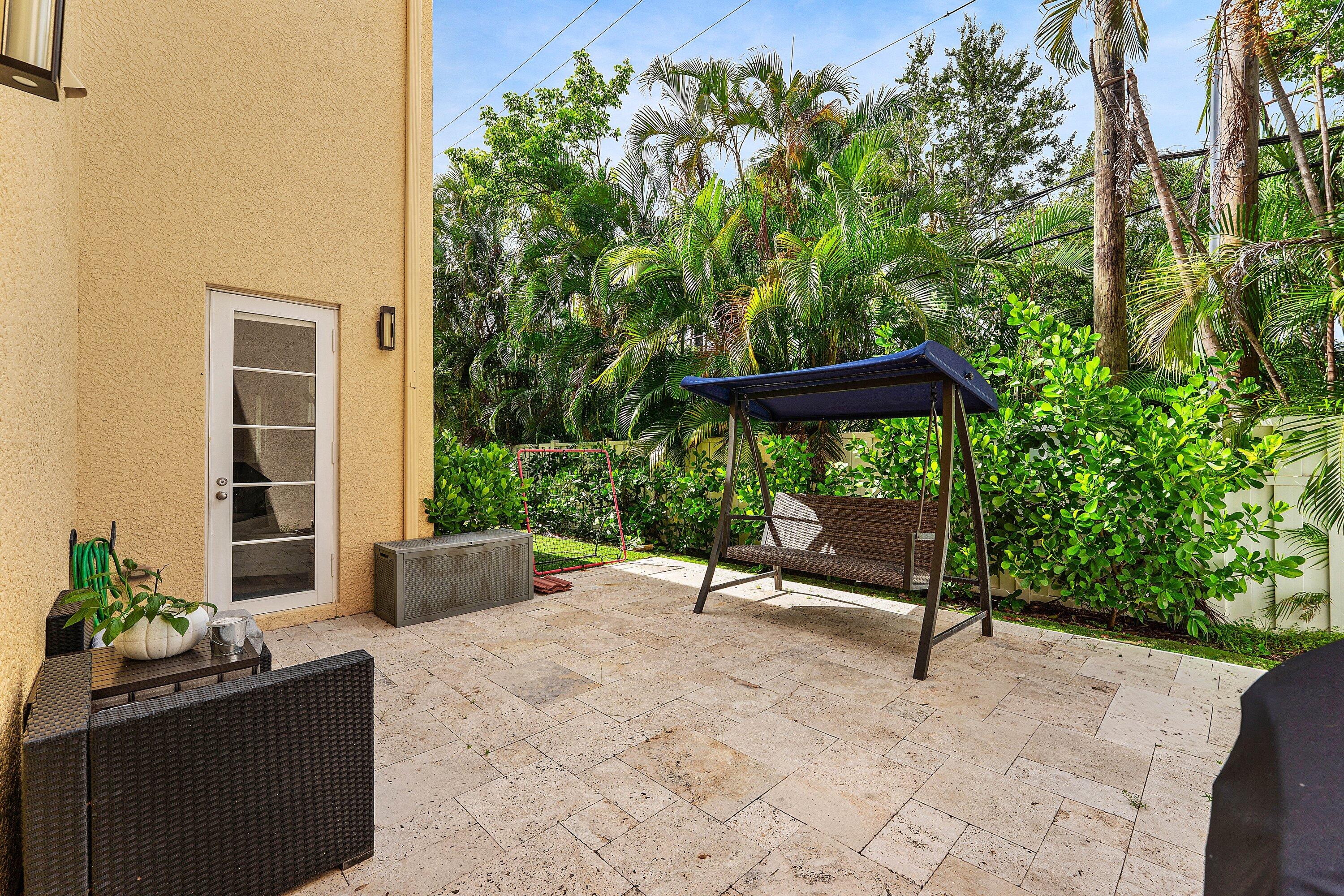 Private outdoor patio with tropical views and seating area.