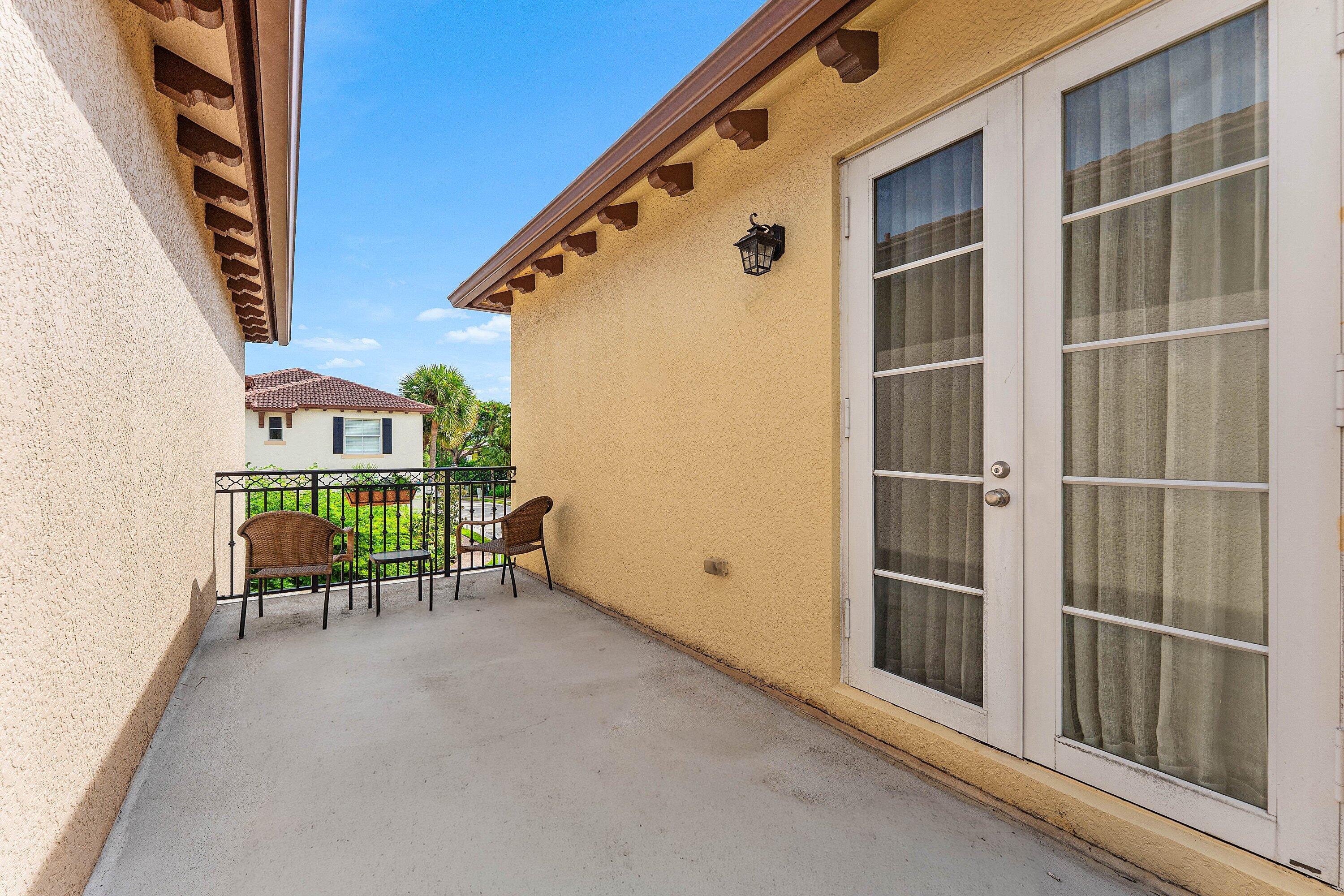 Private patio with French doors and outdoor living space.