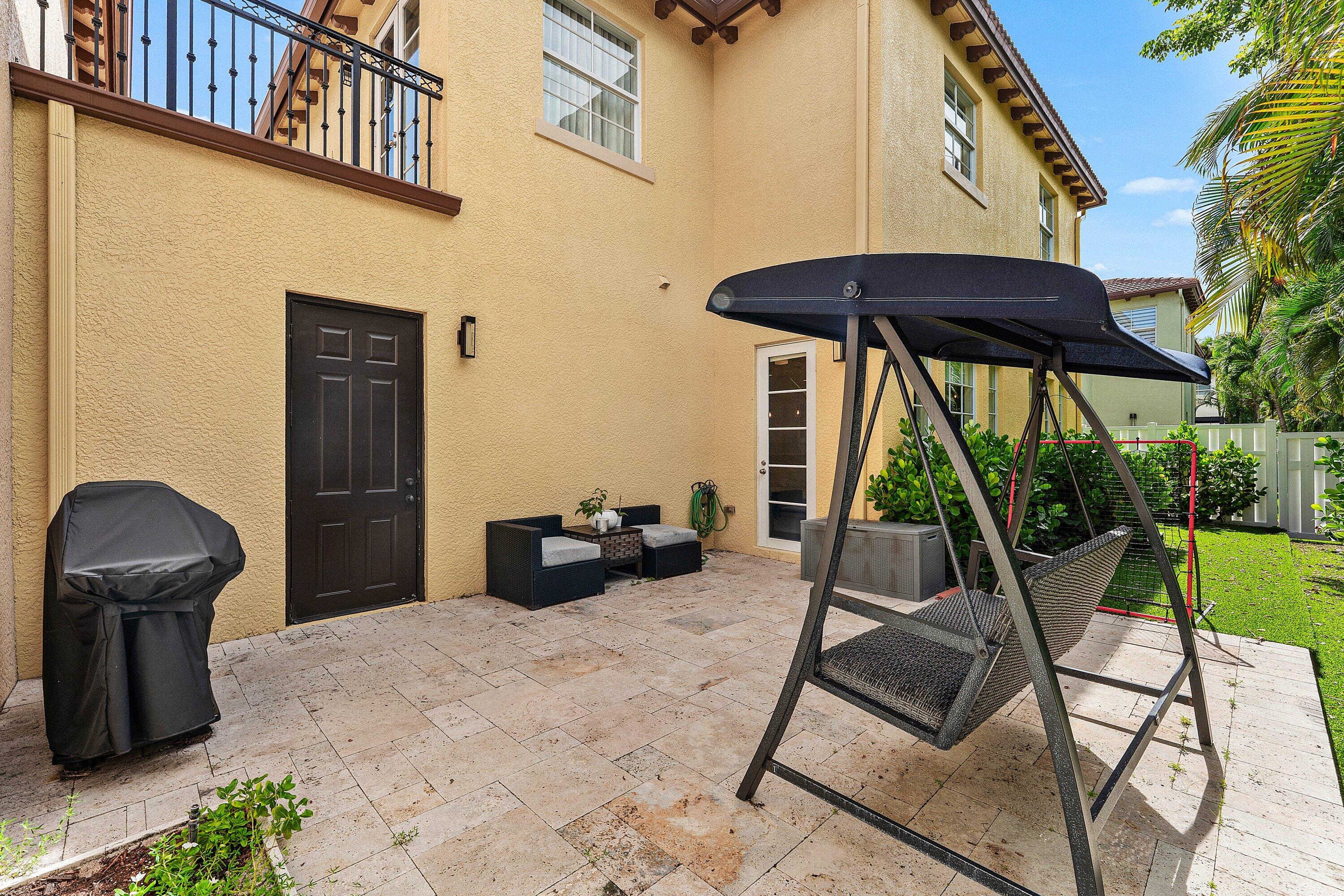 Private outdoor patio with tropical views and seating area.