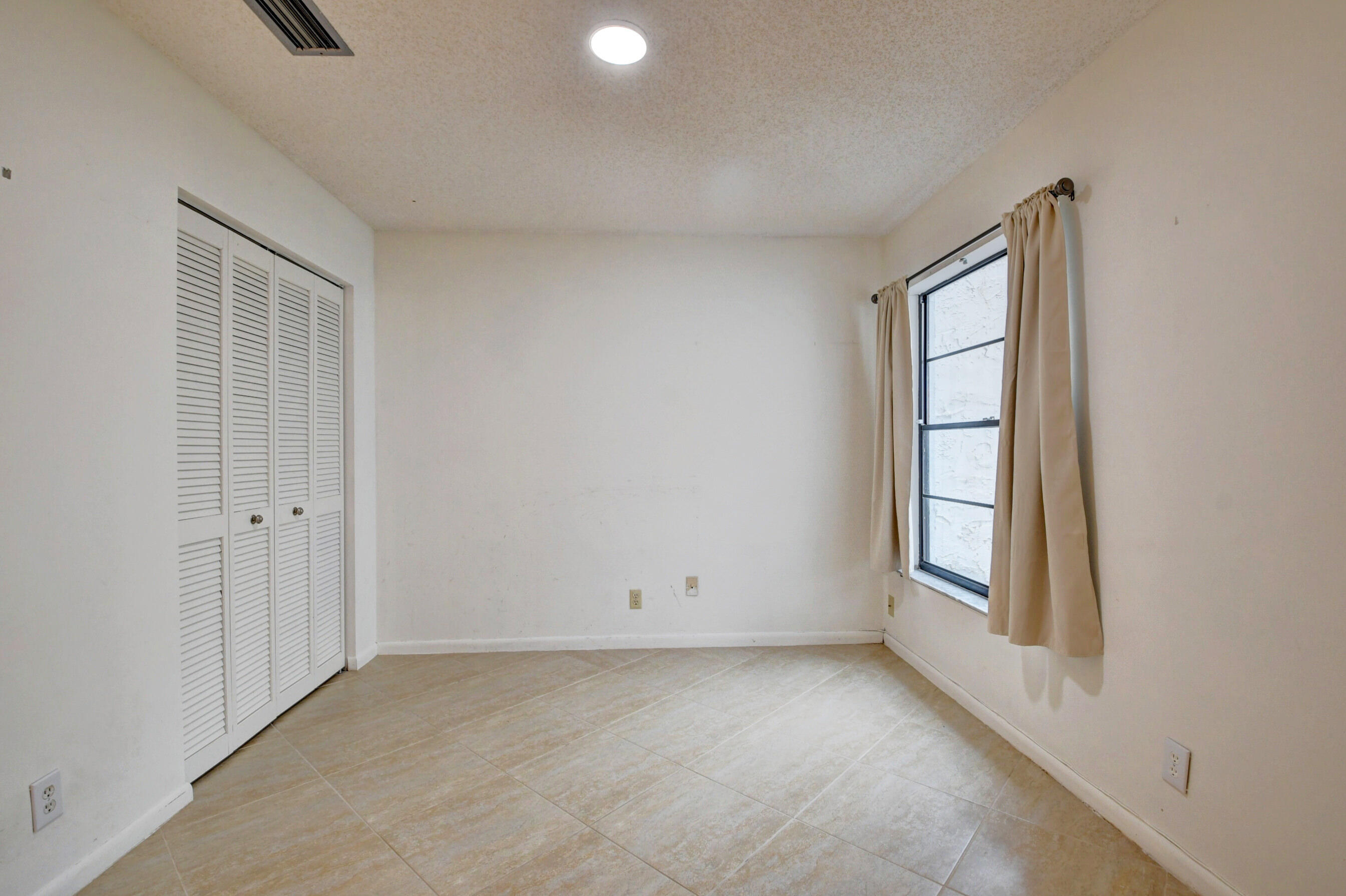 Bright & Inviting Bedroom with Ceiling Fan, Neutral Finishes & Natural Light