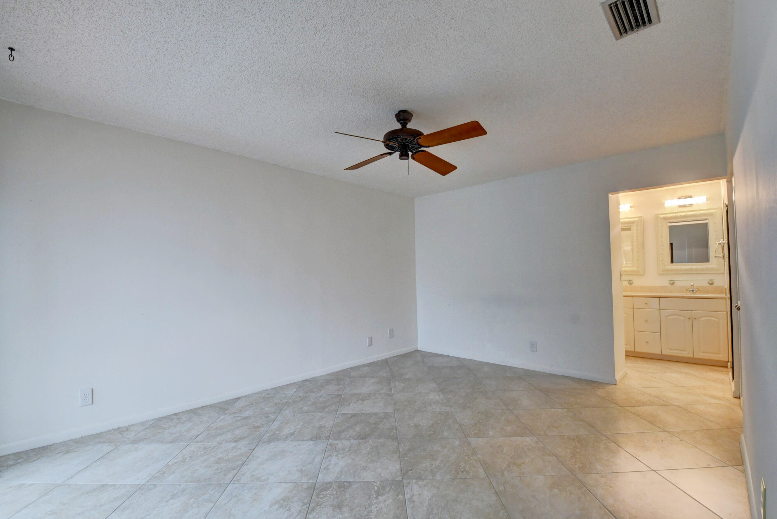 Airy Master Bedroom with Neutral Finishes, Ceiling Fan & Private Bathroom Access