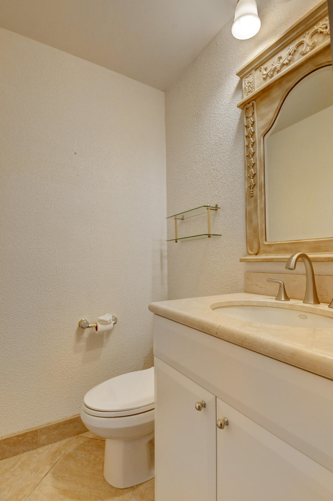 Charming Powder Room with Classic Vanity, Ornate Mirror & Neutral Finishes