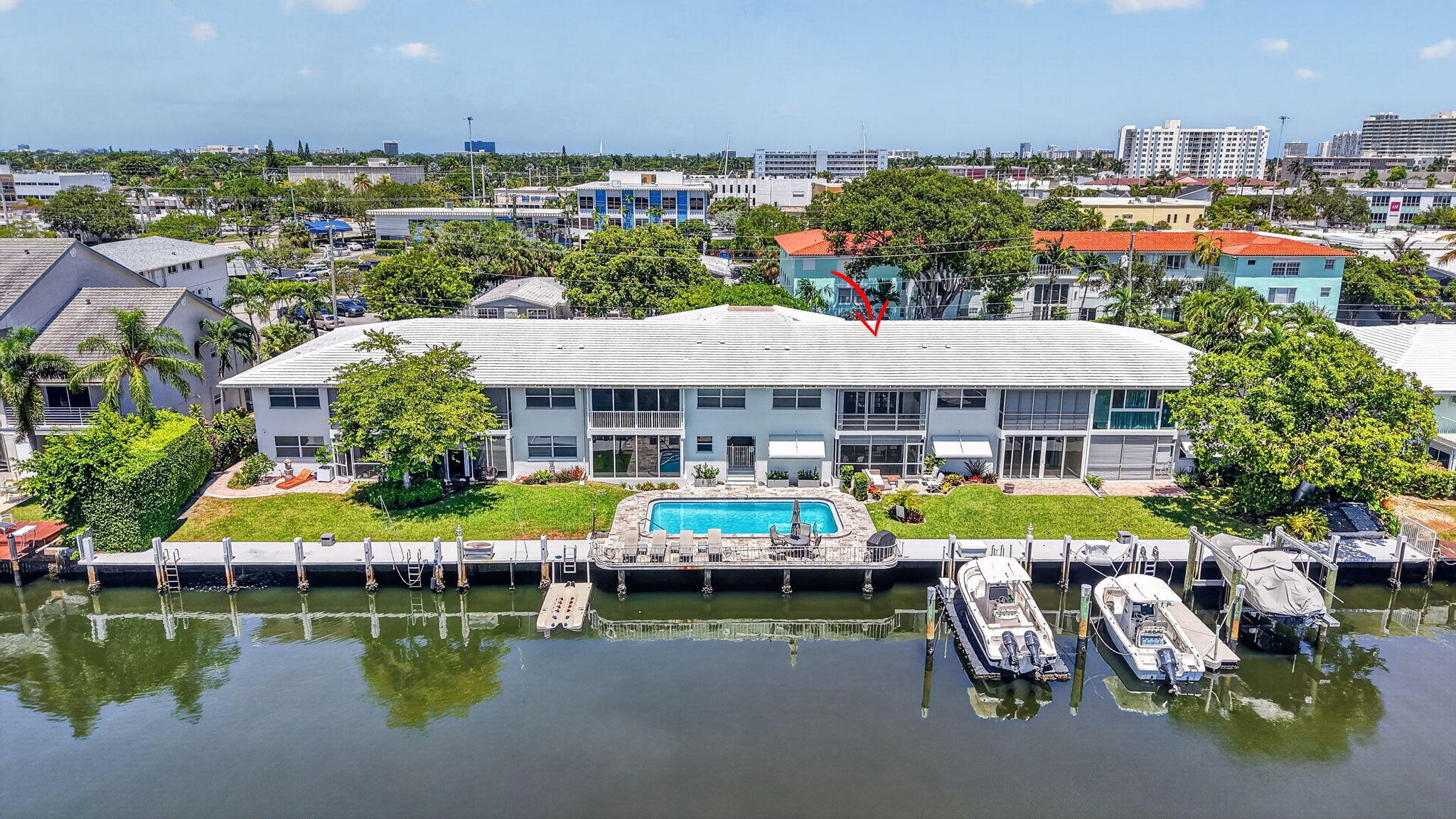 Waterfront property featuring in-ground swimming pool, and a paved pool deck