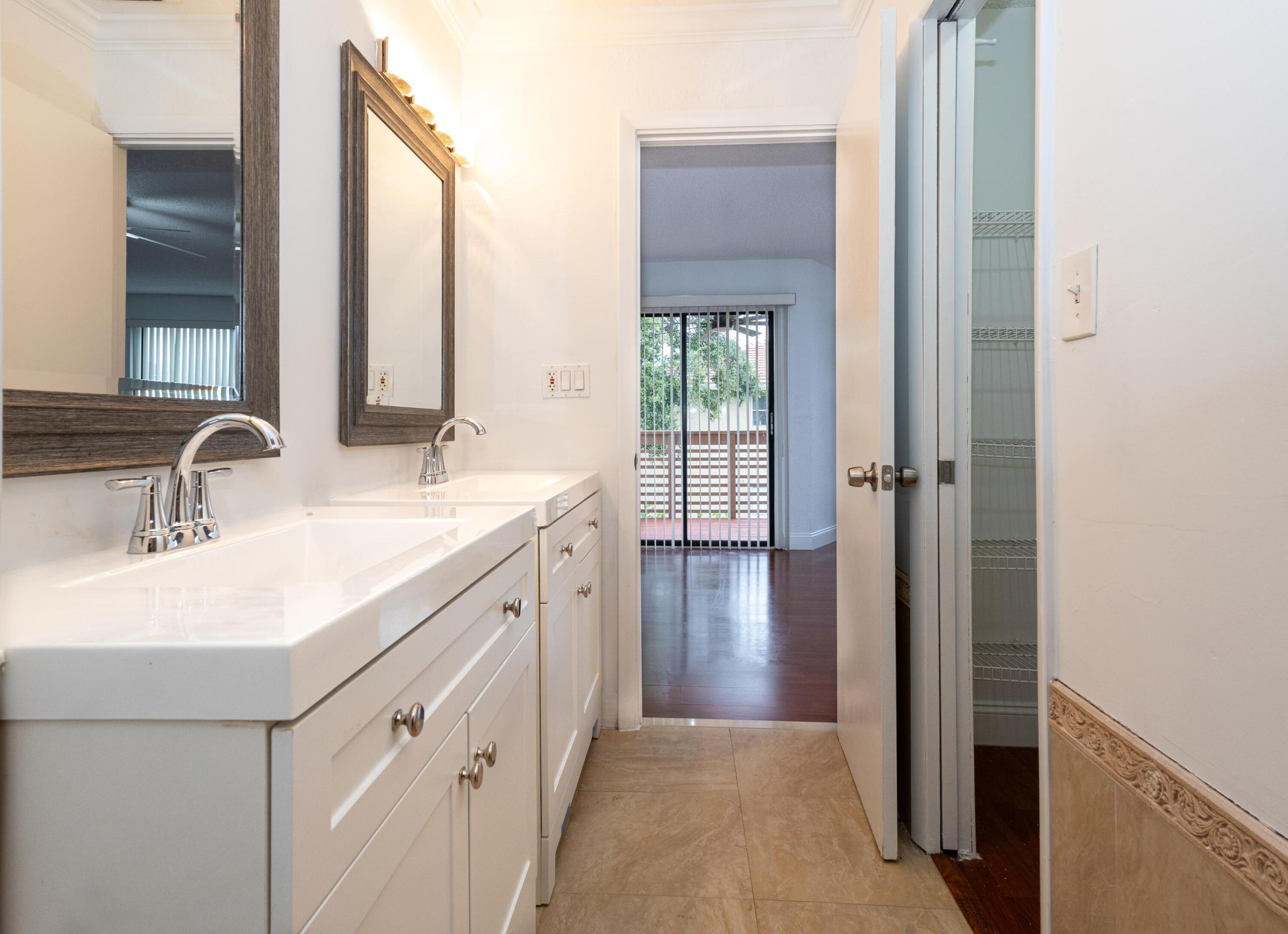 Dual vanity with integrated sinks, framed mirrors, and contemporary lighting