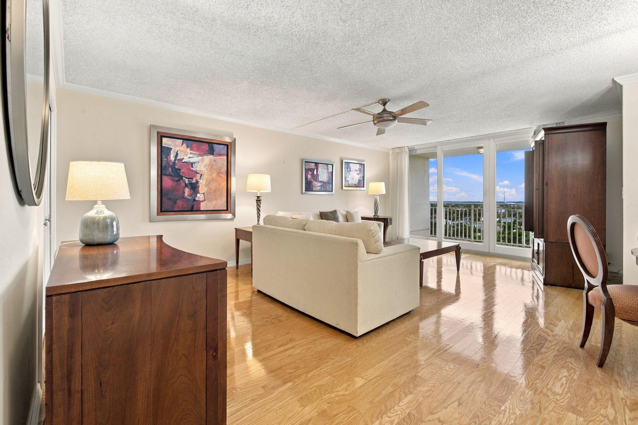 LIVING ROOM LOOKS TOWARDS LARGE BALCONY