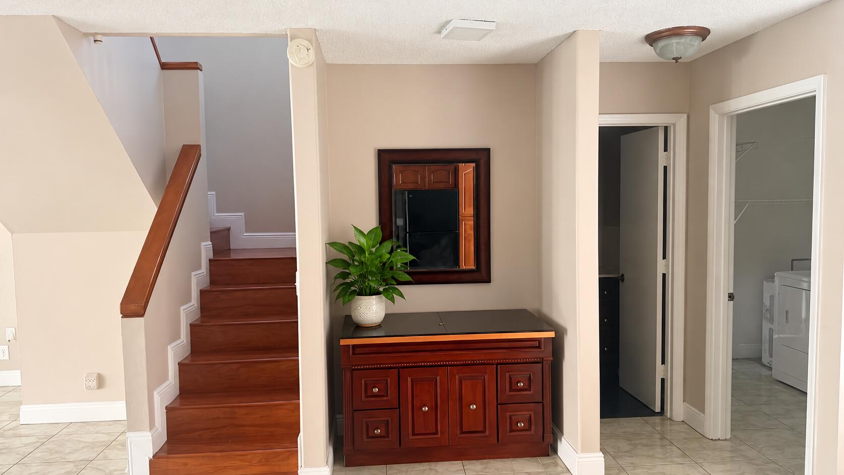 Elegant Foyer with Staircase and Plant