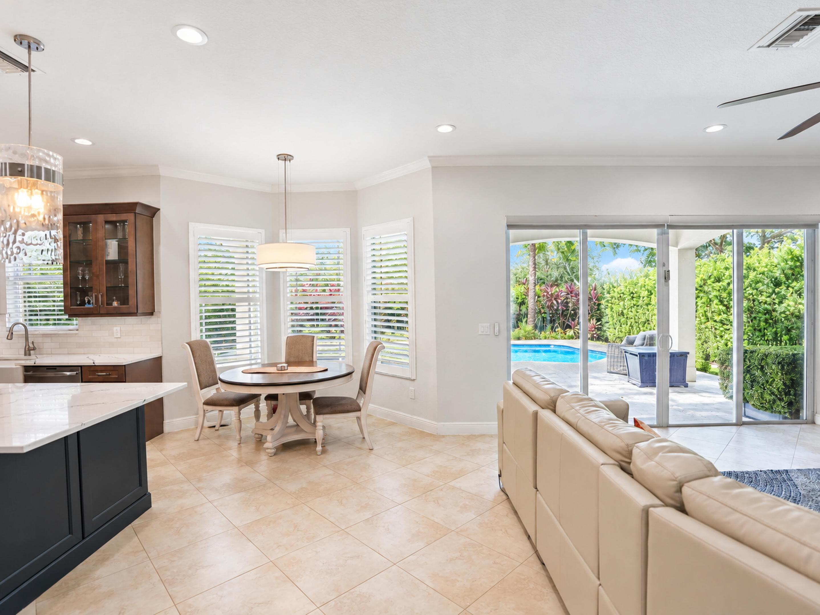 Kitchen featuring dark cabinetry, stone-finish countertops, and tile flooring