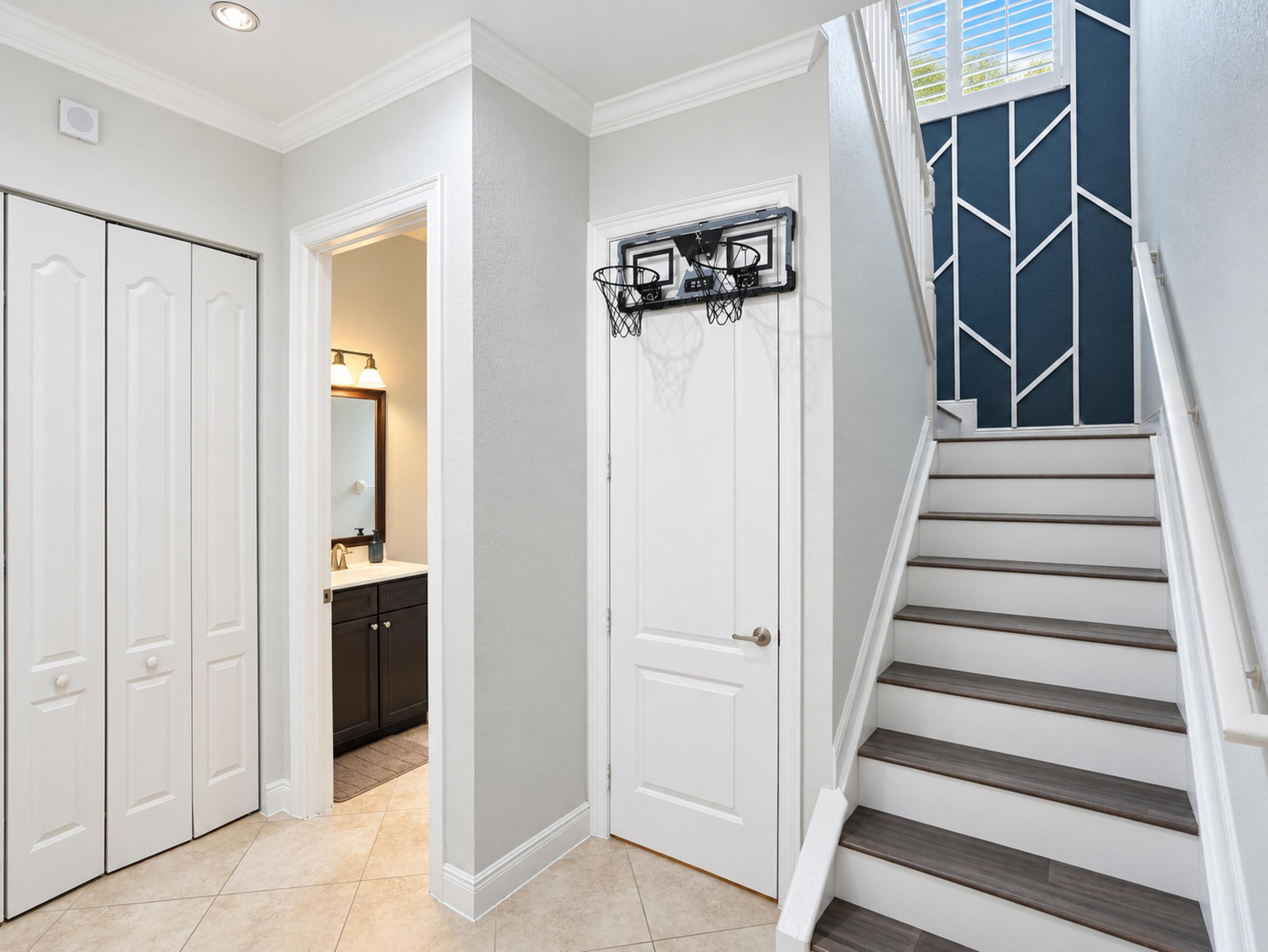 Staircase featuring wood-finish treads, white risers, and decorative wall paneling