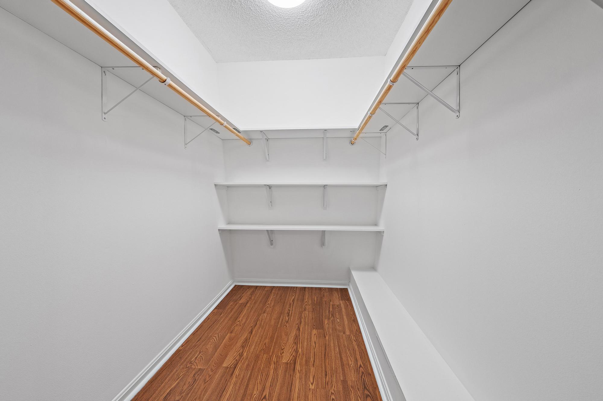 Primary bedroom walk in closet