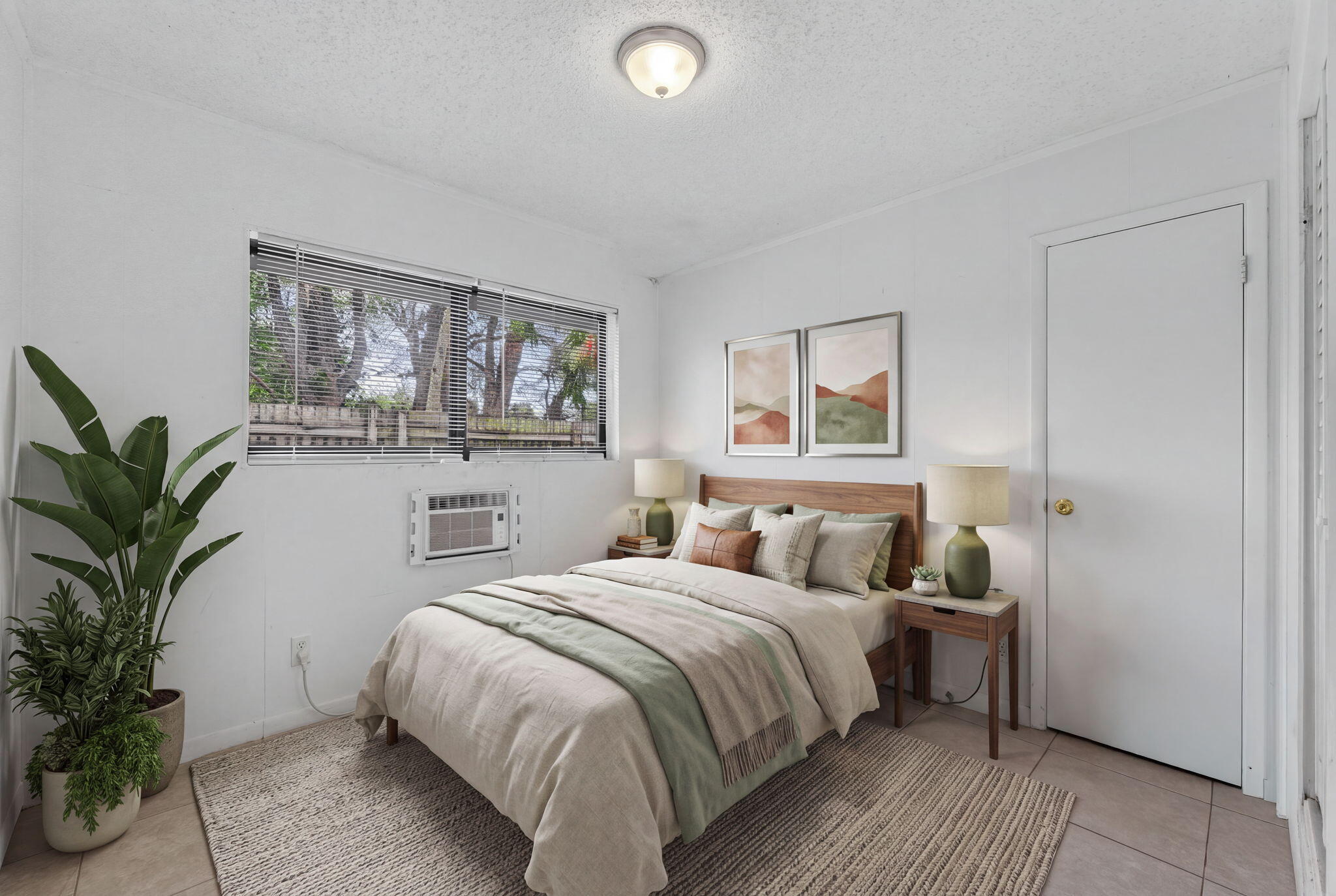 Neutral-toned interior space featuring light-colored tile flooring, flush-mount lighting, and a window with horizontal blinds