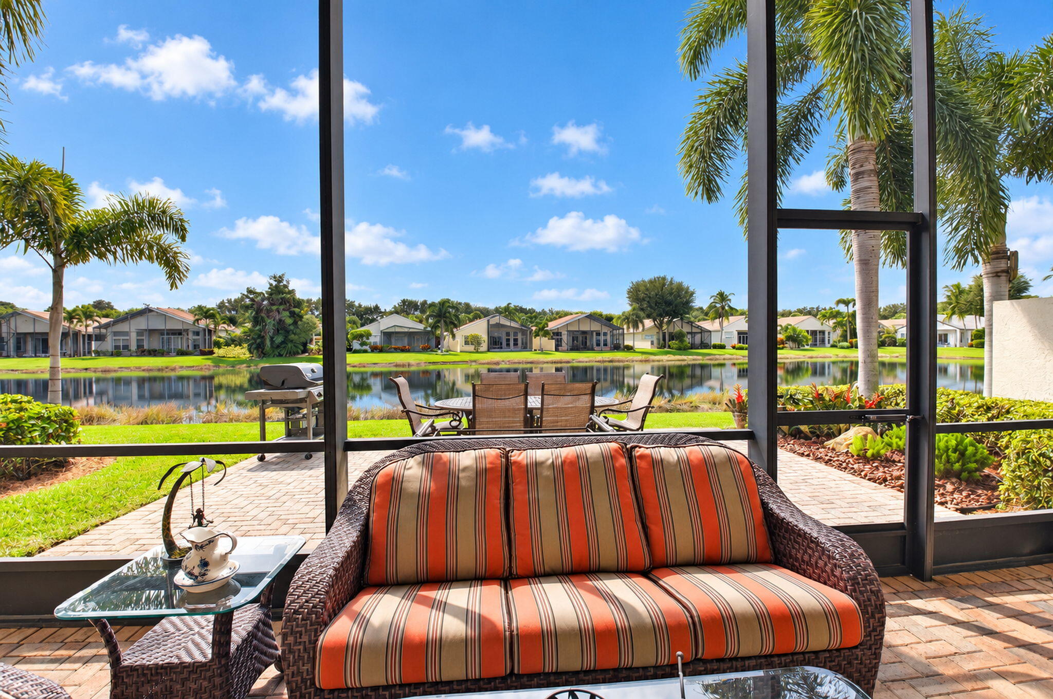 Screened-in lanai featuring paver flooring and water frontage