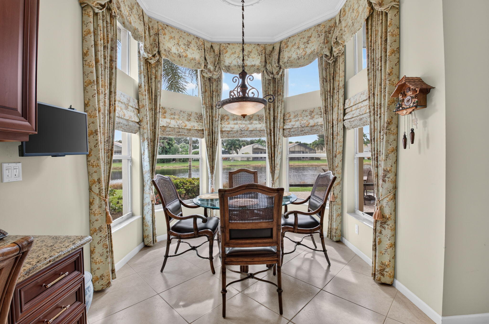 Bay window featuring floor-to-ceiling windows, tile flooring, and a multi-light metal chandelier