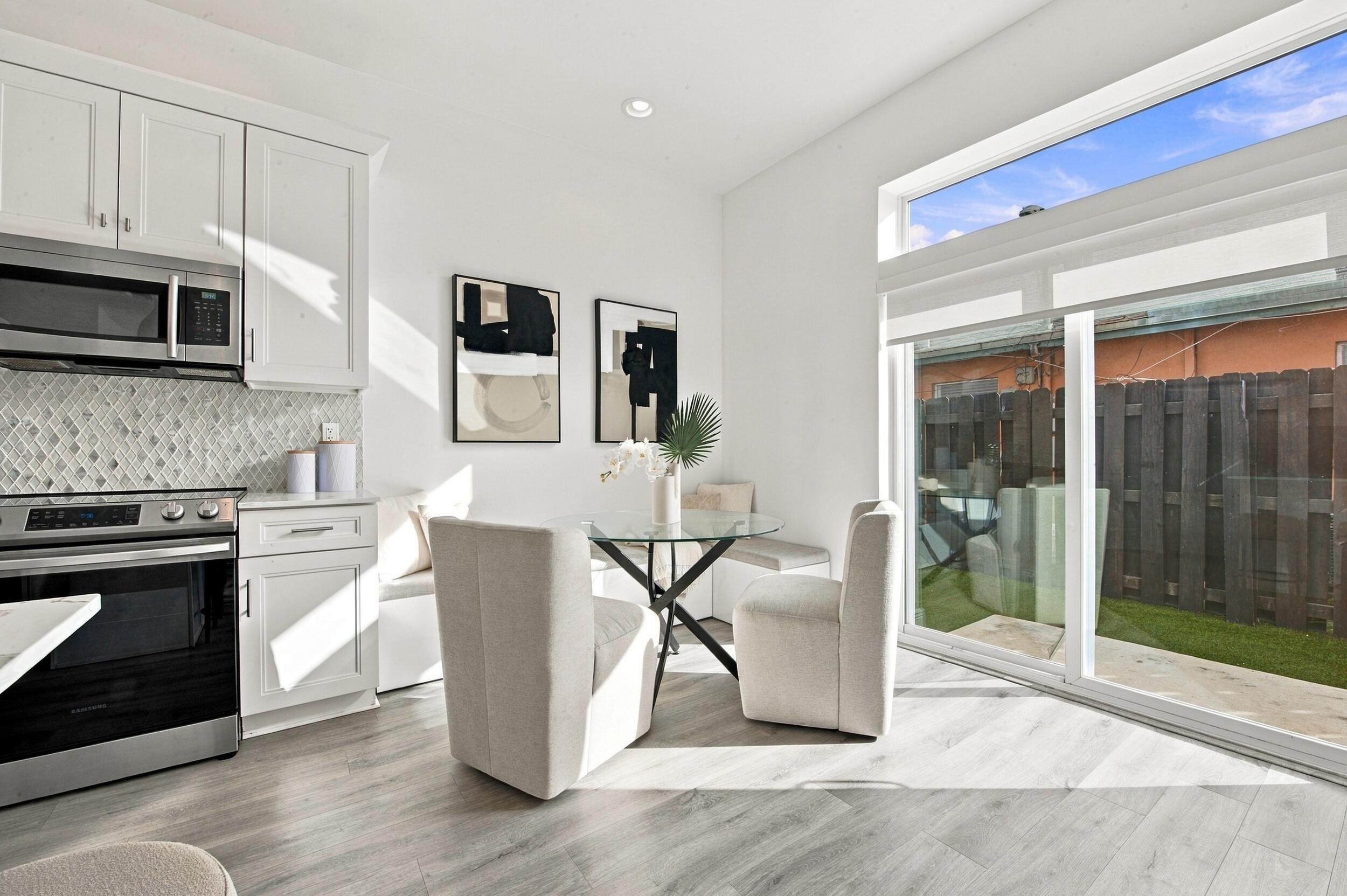 Built-in bench seating, wood-finish flooring, sliding glass door with transom window, and wall-mounted shelving Built-in bench seating, wood-finish flooring, sliding glass door with transom window, and wall-mounted shelving
