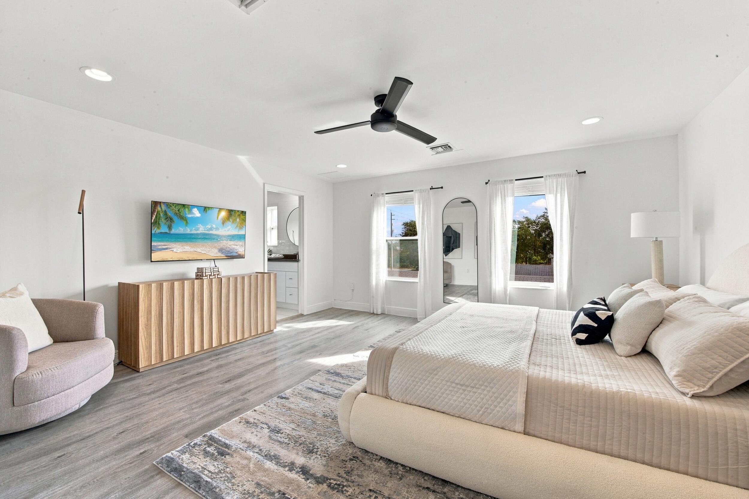 Room featuring wood-finish flooring, recessed lighting, and a matte black ceiling fan