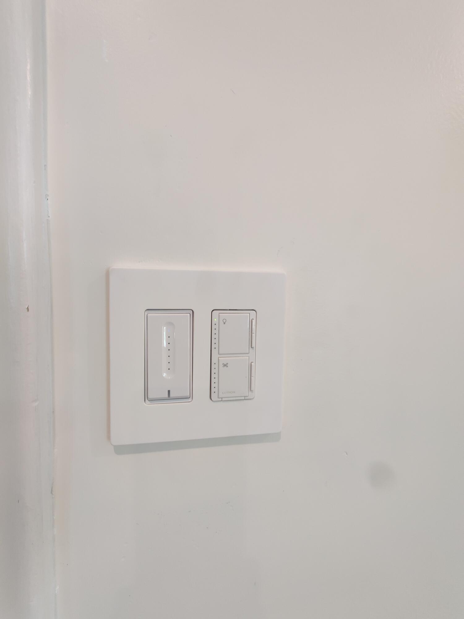 Modern white dual-rocker light switch featuring an integrated vertical dimmer slider and clean-finish wall plate
