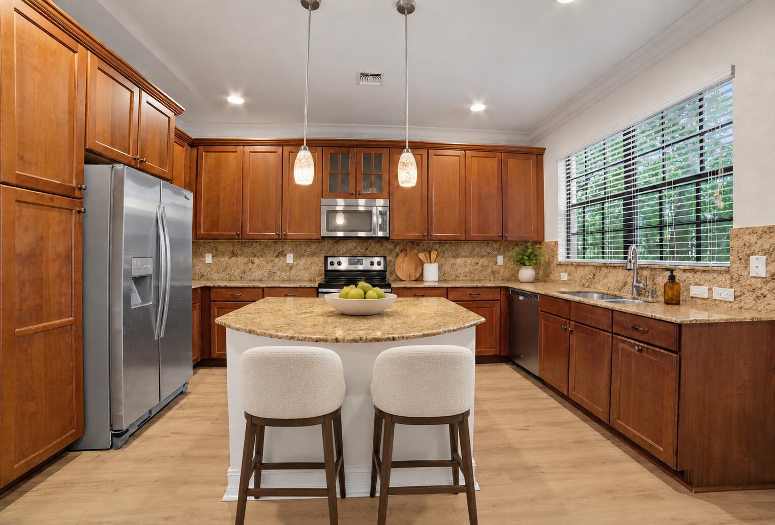 Kitchen featuring wood cabinetry, stone countertops, stainless steel appliances, a central island, and recessed lighting