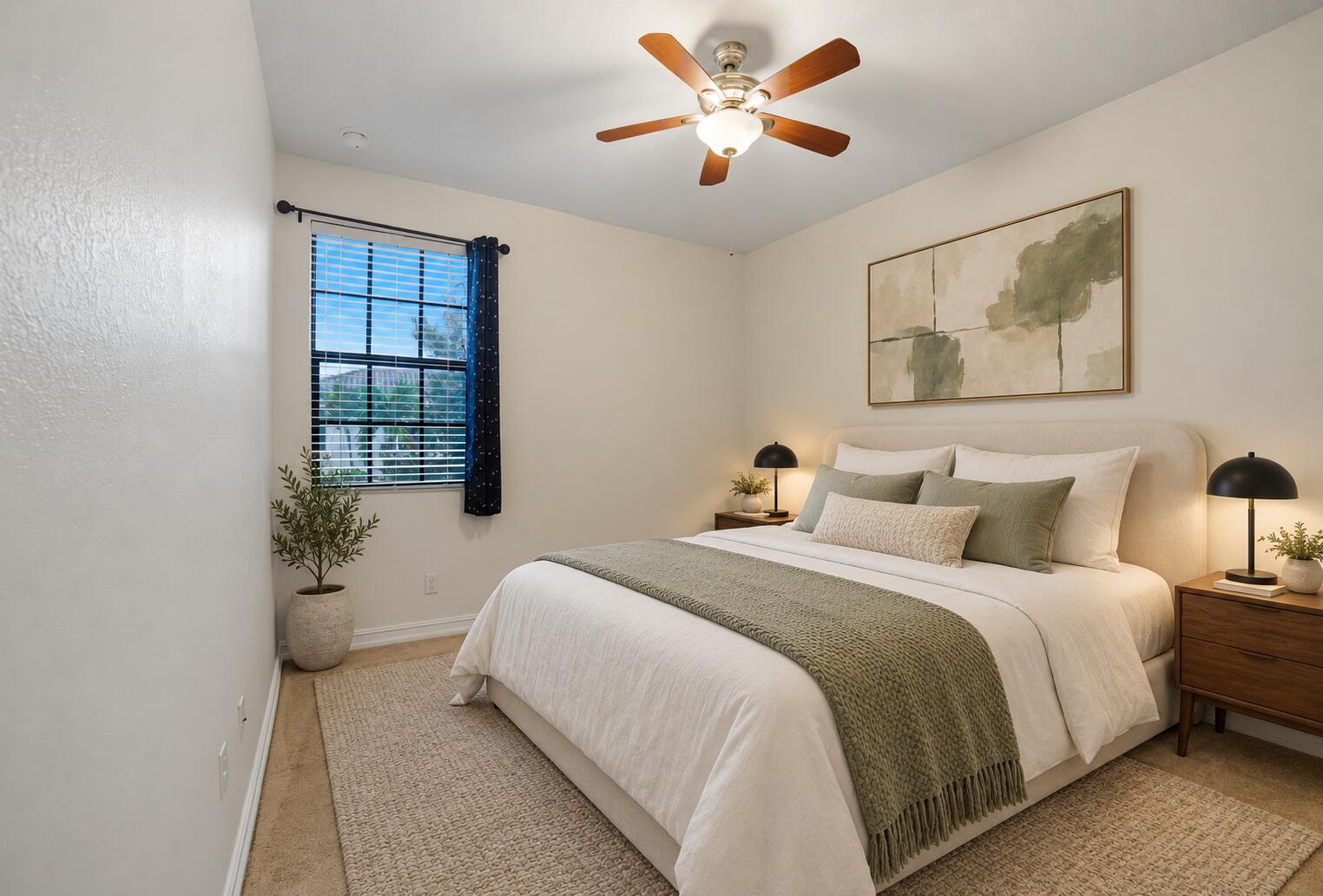 Neutral interior featuring neutral wall paint, multi-blade ceiling fan with integrated lighting, window with horizontal blinds, and carpeted flooring
