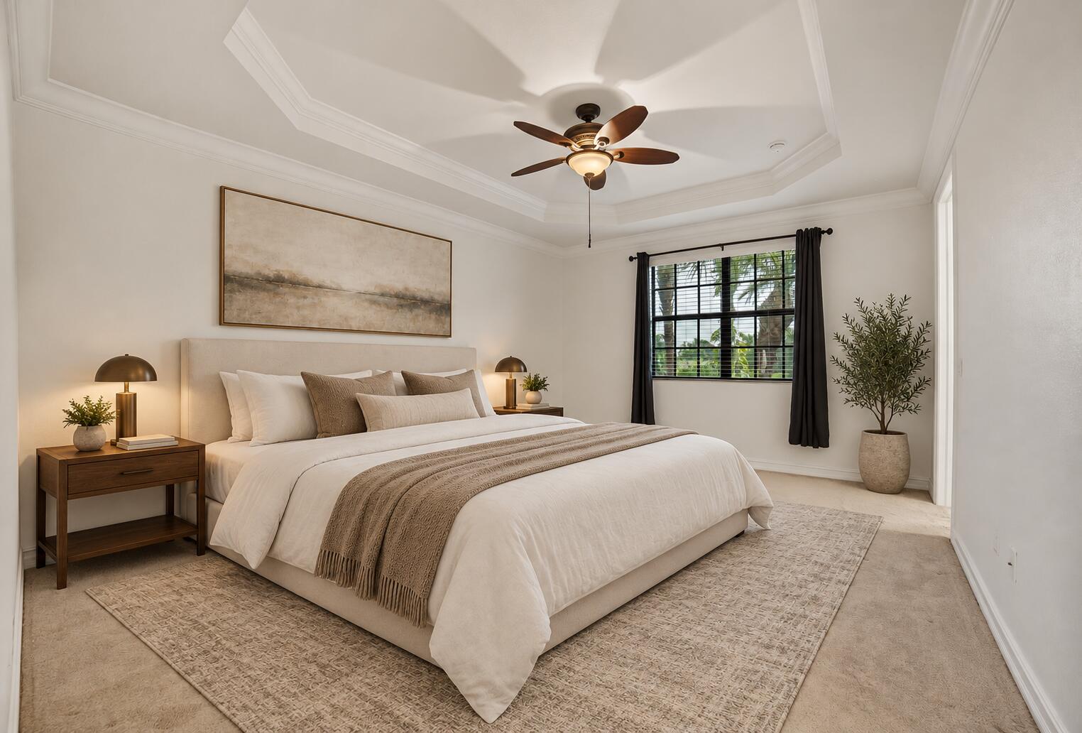 Tray ceiling, ceiling fan with integrated lighting, neutral wall-to-wall carpeting, and multi-pane window