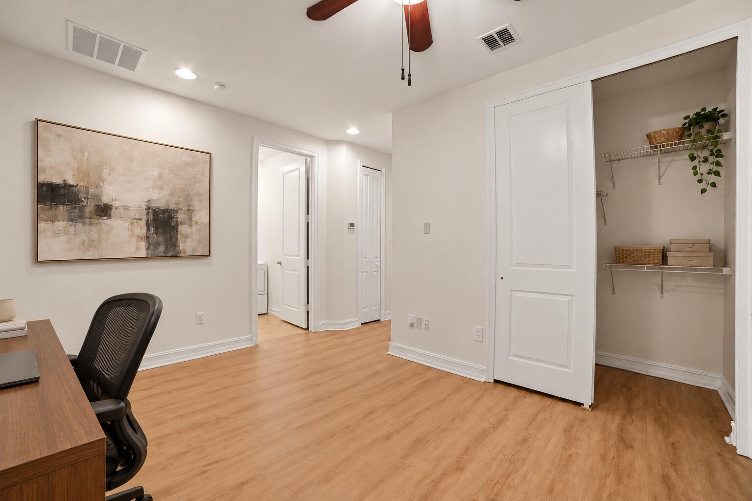 Interior space featuring wood-finish flooring, a ceiling fan with integrated lighting, recessed lighting, and a closet with wire shelving