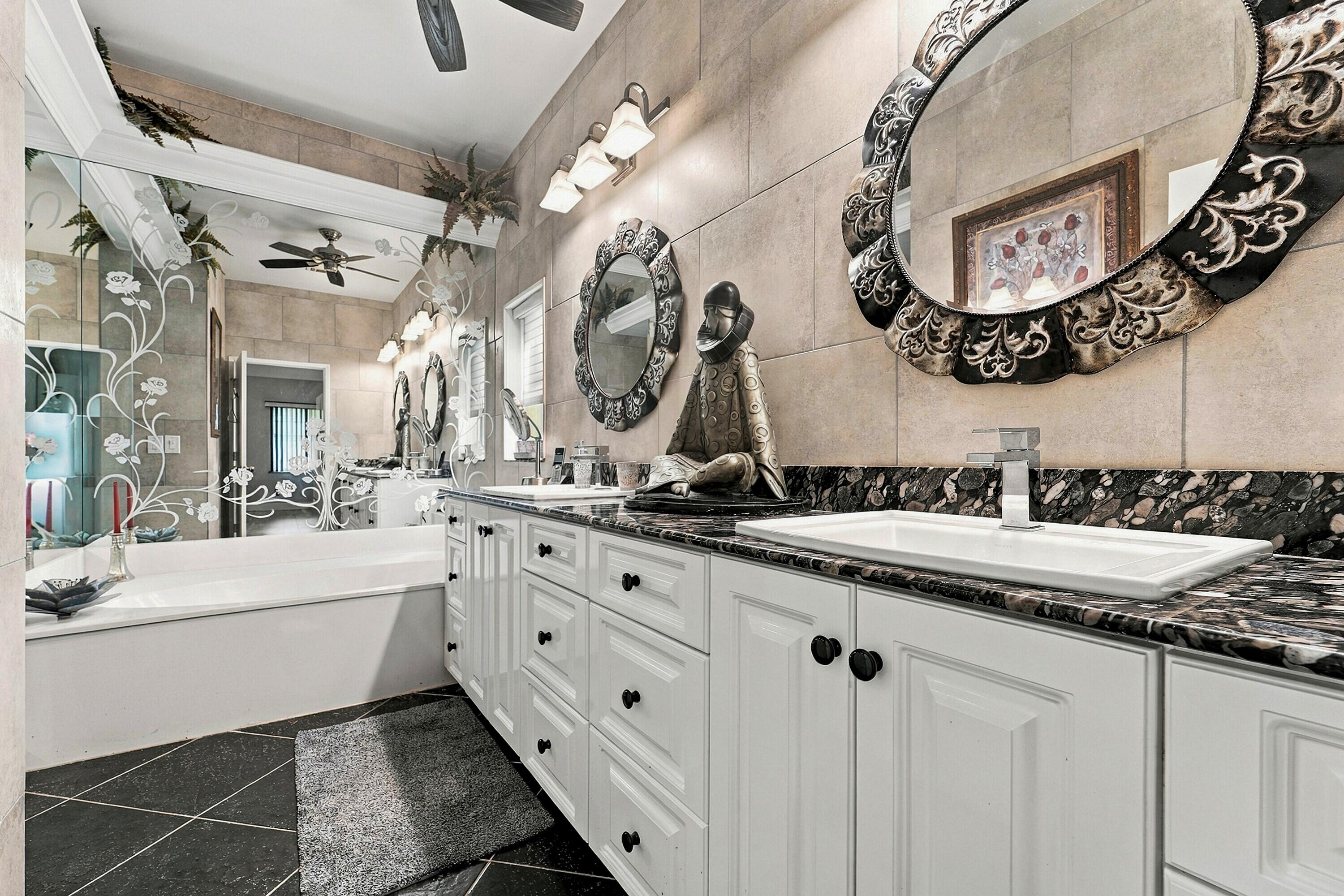 Has tub & shower, granite tops, black slate flooring.