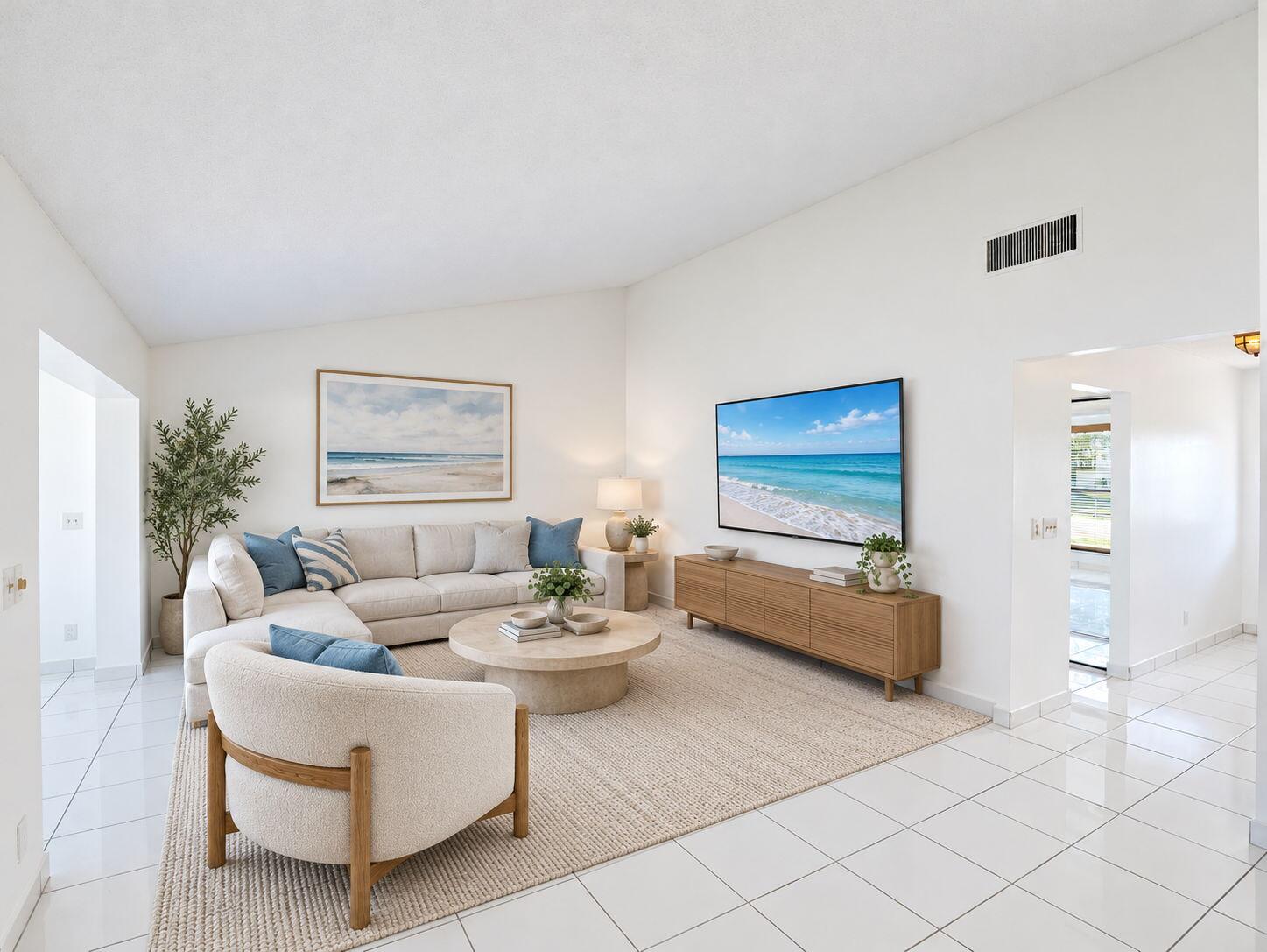 Living space featuring high vaulted ceilings, expansive white tile flooring, and neutral wall tones