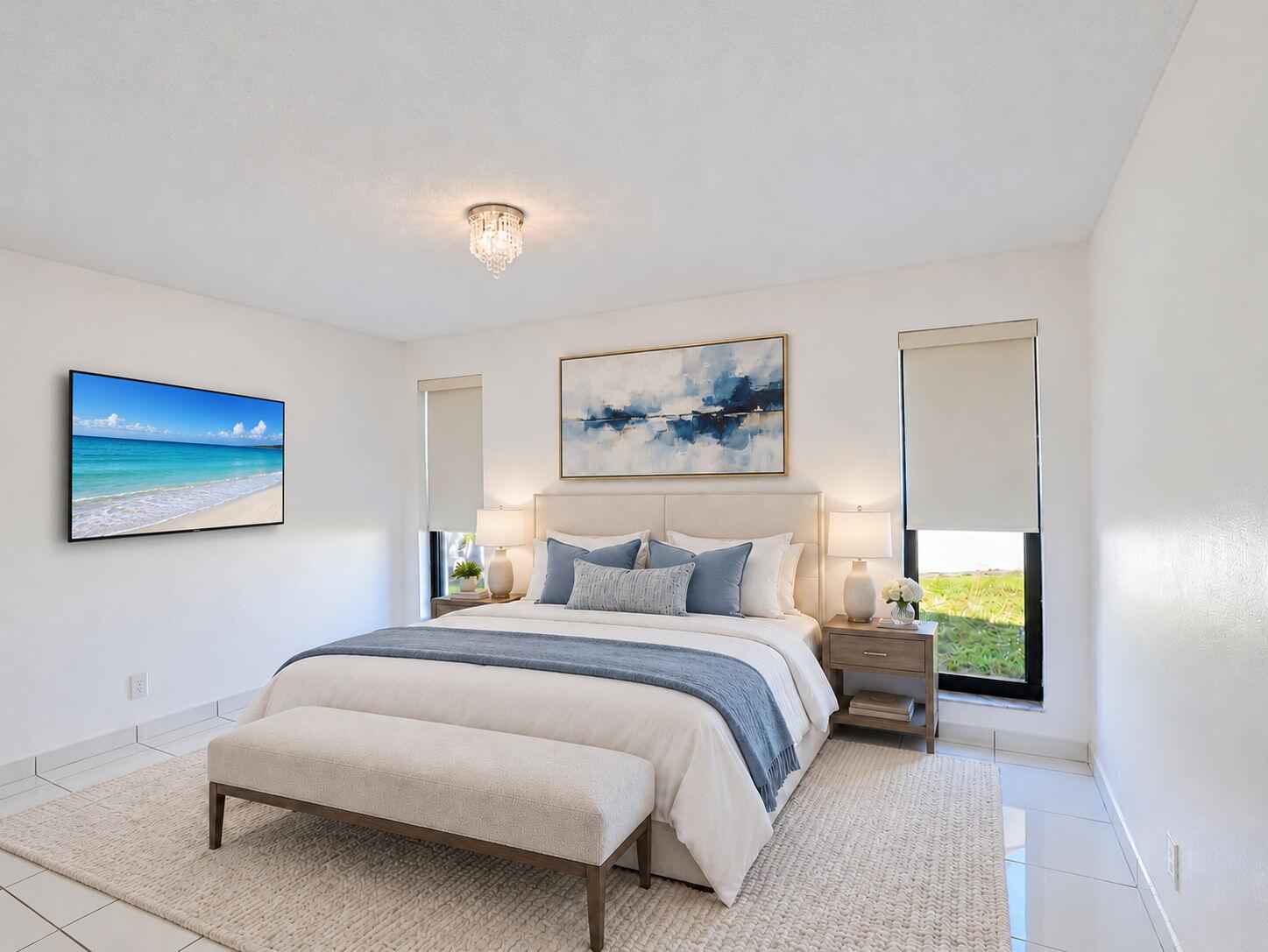 Neutral-toned interior space featuring light-colored tile flooring, floor-to-ceiling windows with roller shades, and a crystal flush-mount ceiling light fixture