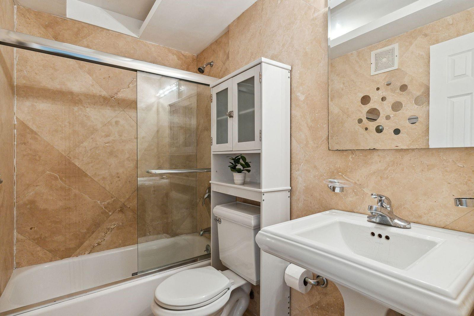 Marble bathroom tub-shower with glass door