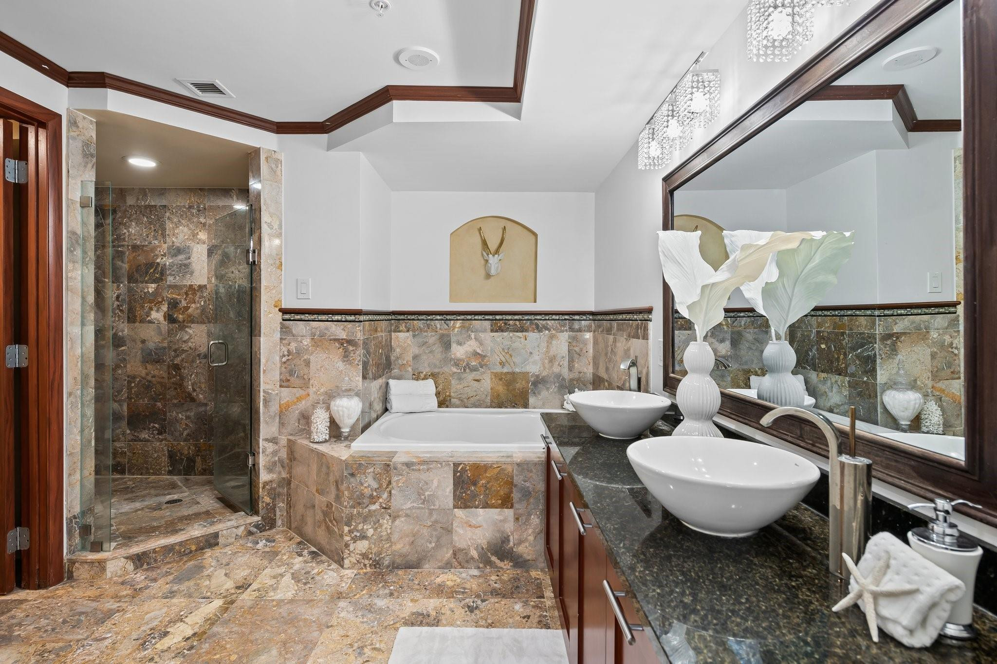 Owners bathroom with walk in shower and spa tub.