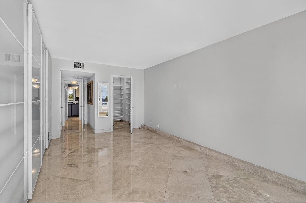 Main Residence - Guest Bedroom with walk-in closet, built-in closets and an additional closet.
