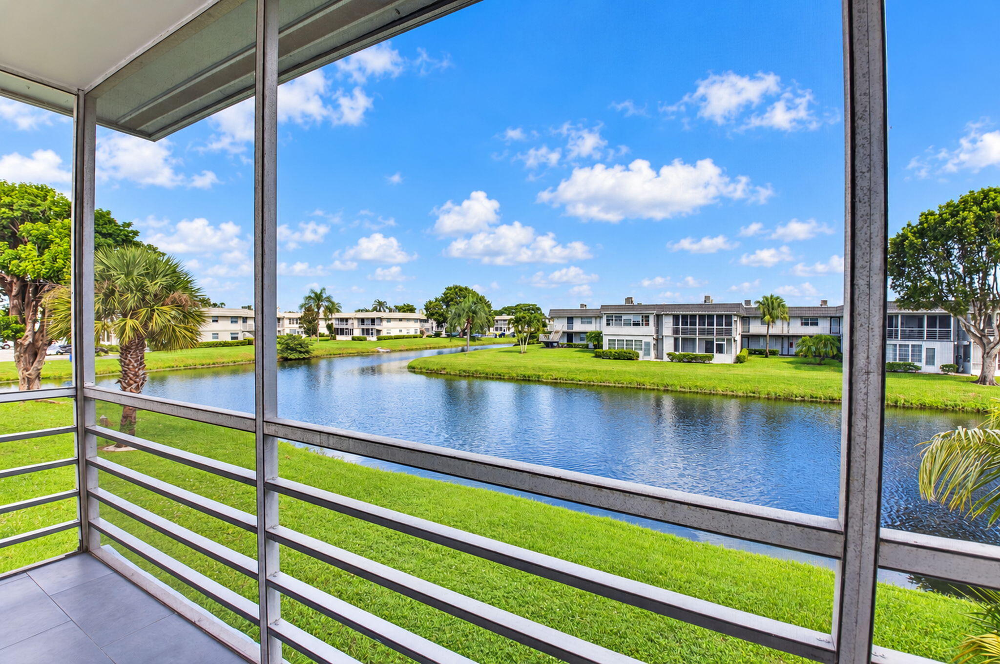 East exposure on covered and screened balcony with water view.