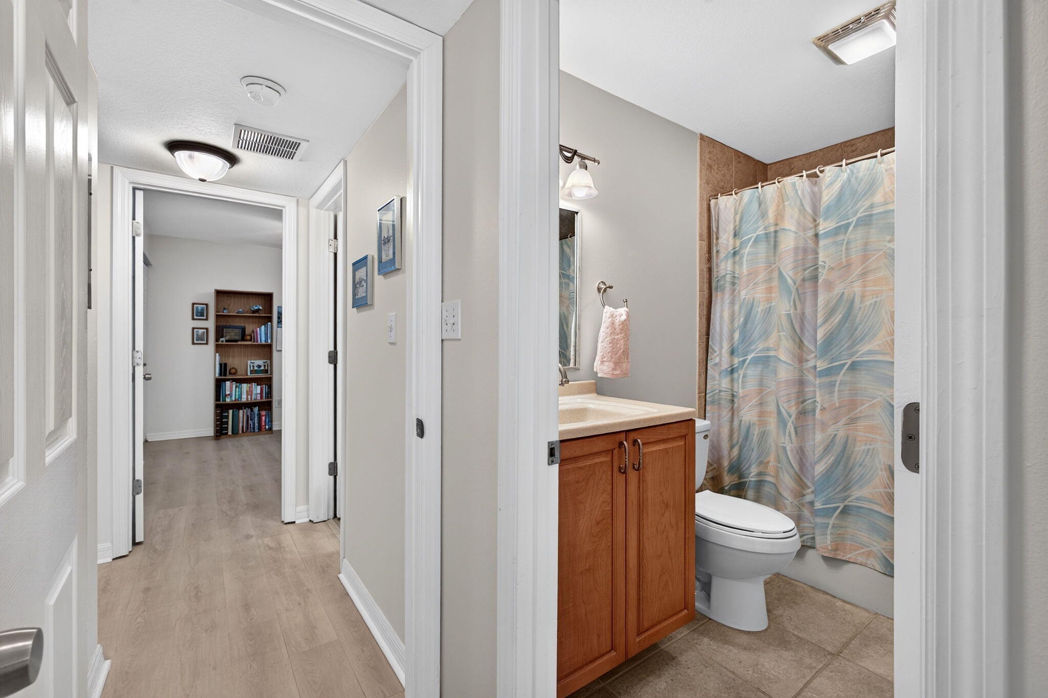 Clean, bright hallway connects the private bedroom wing