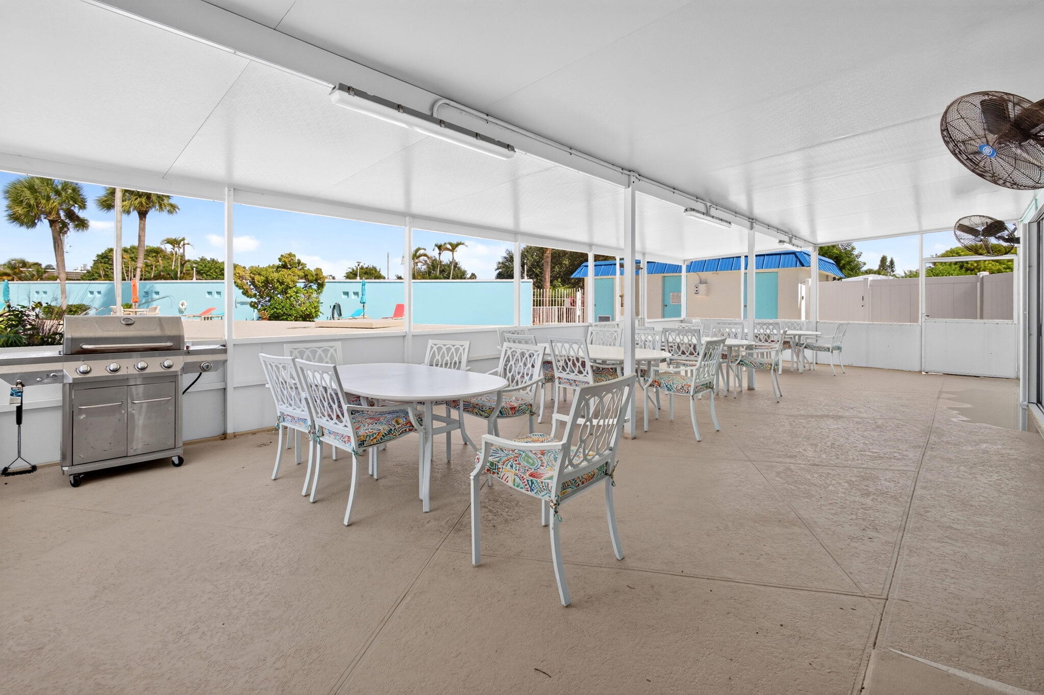 Covered outdoor gathering space beside the pool.
