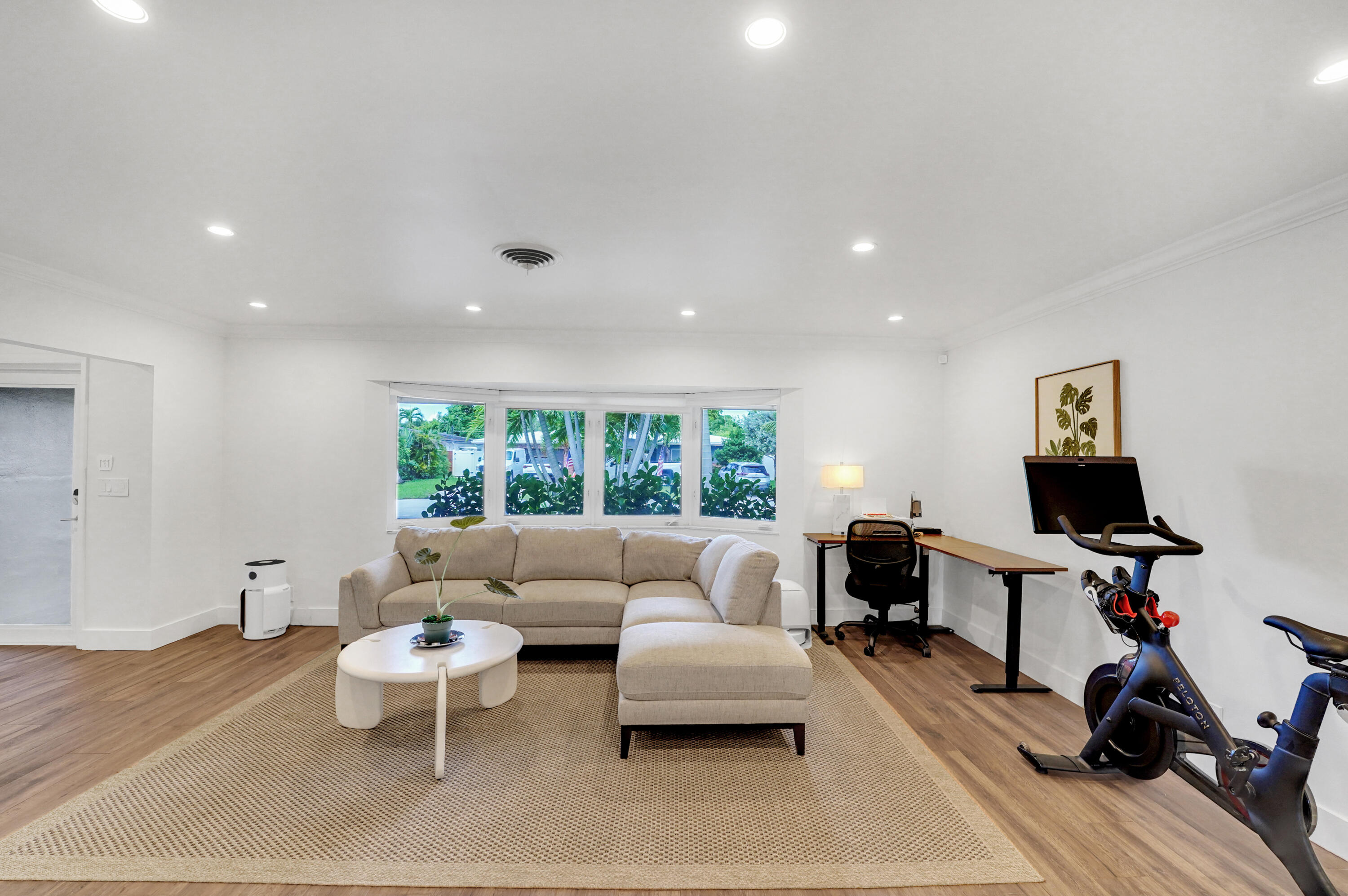 Spacious room featuring recessed lighting, and a large multi-pane bay window