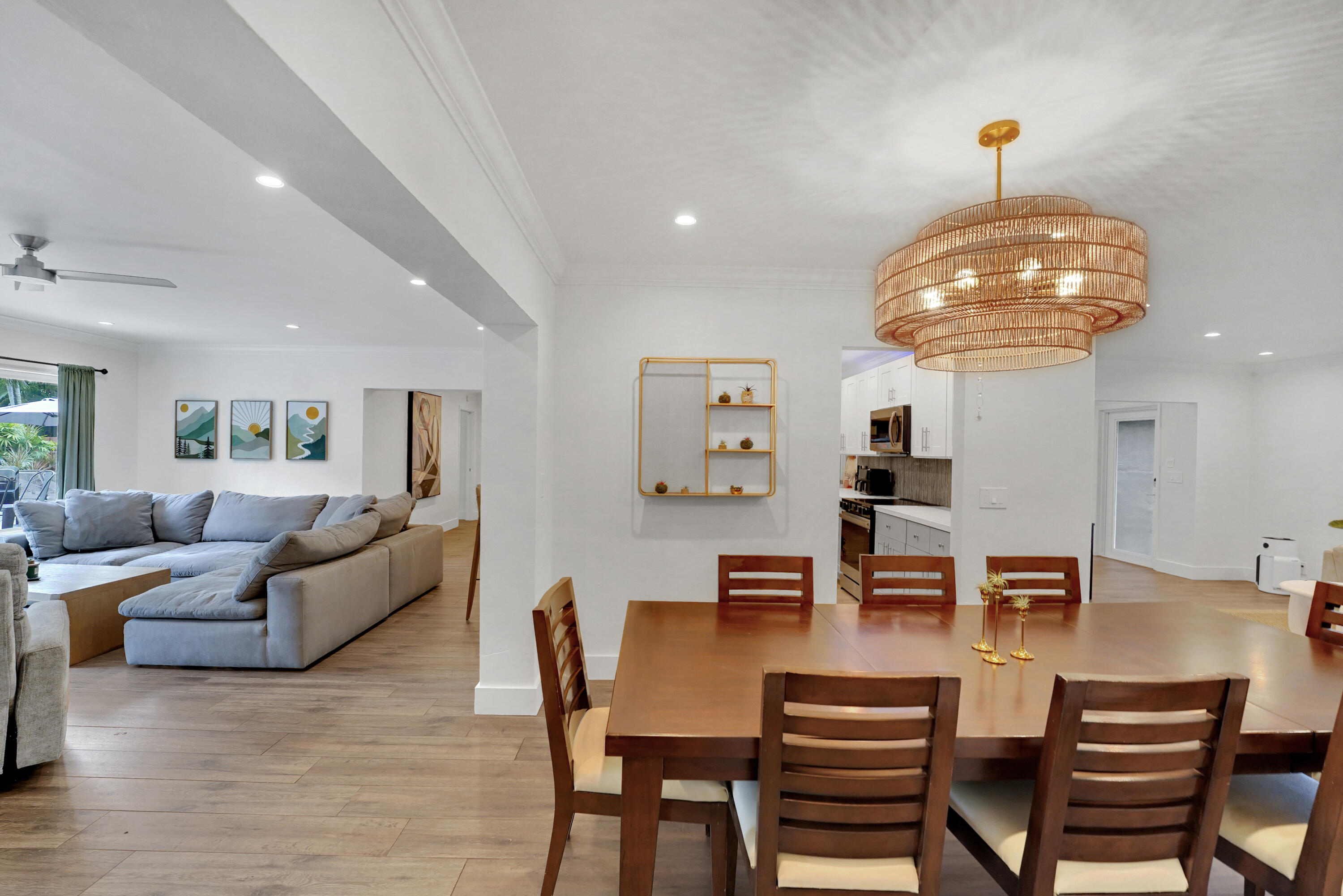 Open-concept interior featuring, recessed lighting, and a tiered woven-texture chandelier