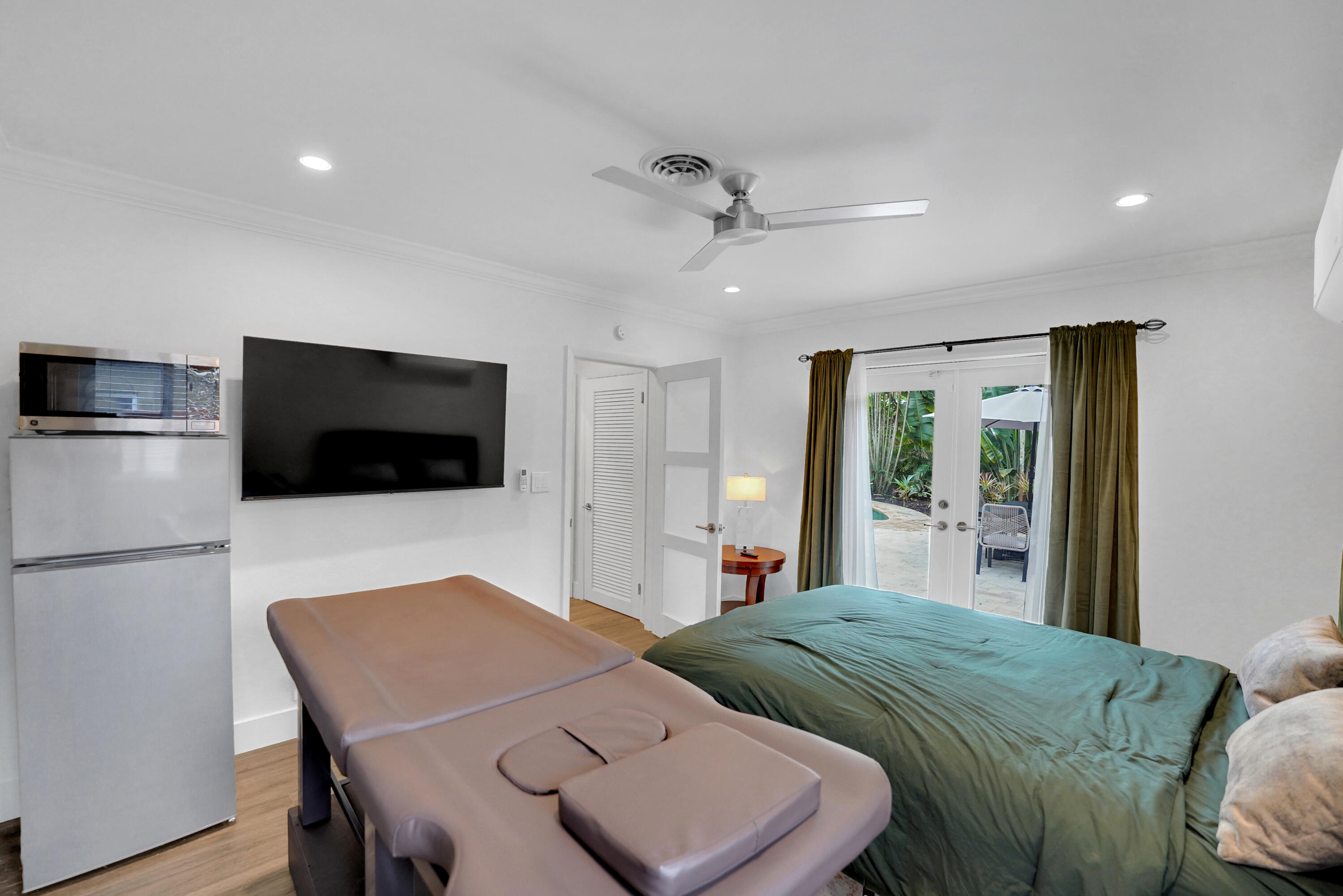 Interior space featuring wood-finish flooring, recessed lighting, a ceiling fan, and French doors