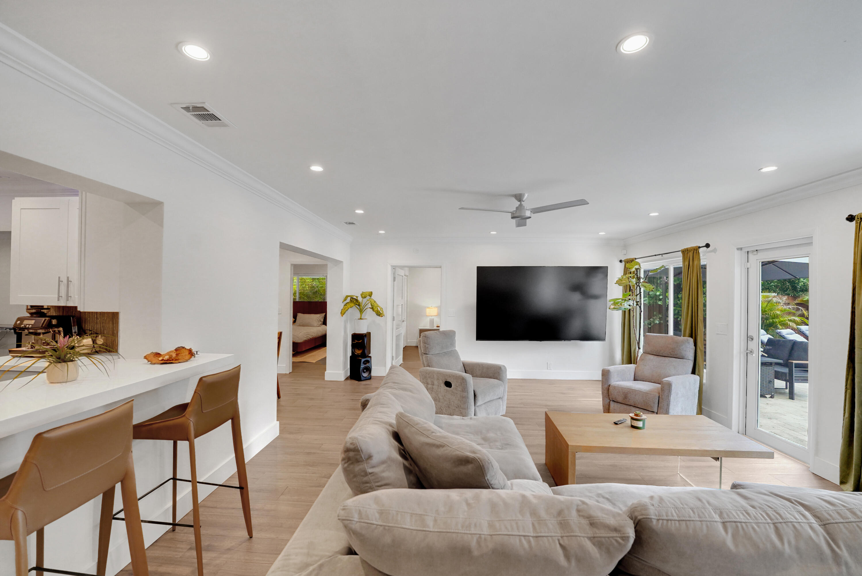 Open-concept living space featuring recessed lighting, a modern ceiling fan, and sliding glass doors to the exterior