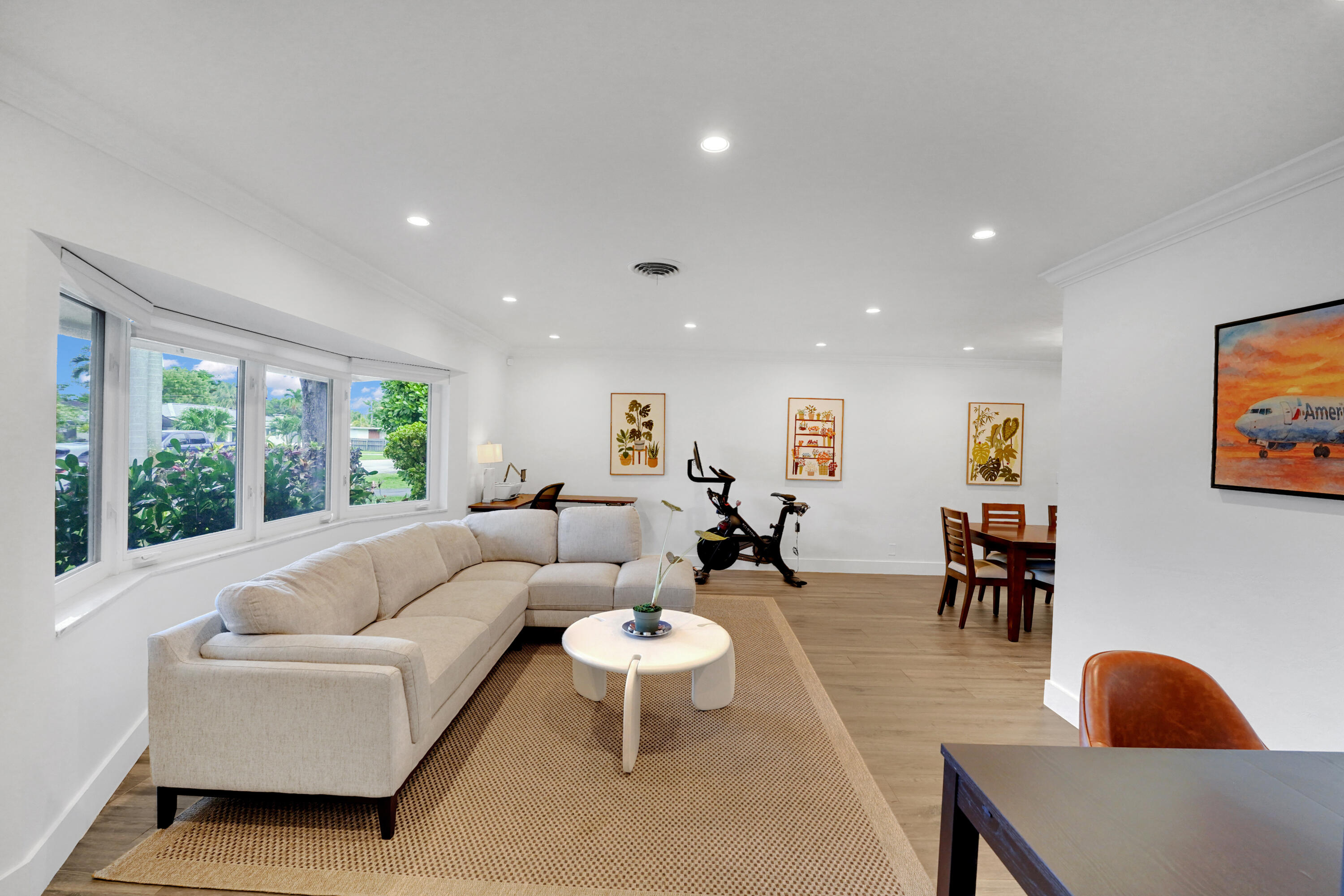 Open-concept living space featuring recessed lighting, and a large bay window