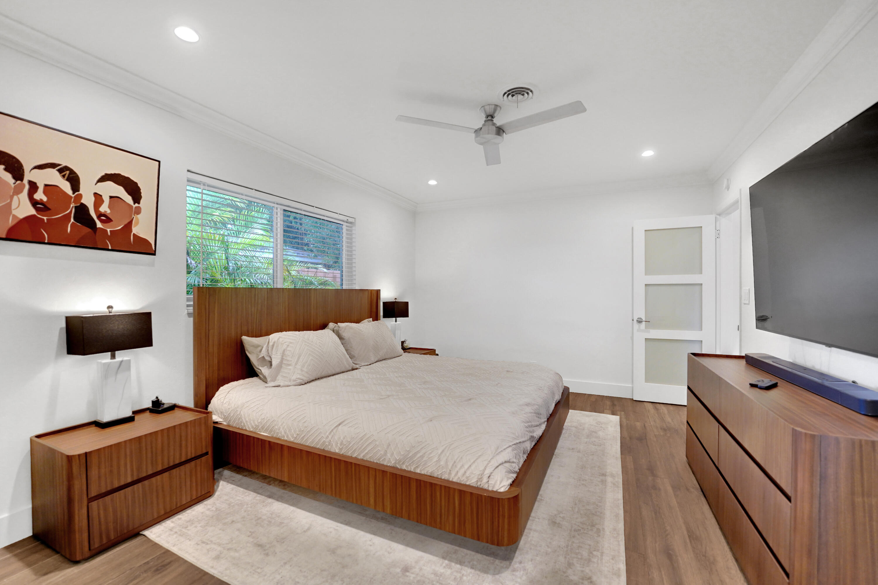 Room featuring wood-finish flooring, recessed lighting, a ceiling fan, and a three-panel door with frosted glass inserts