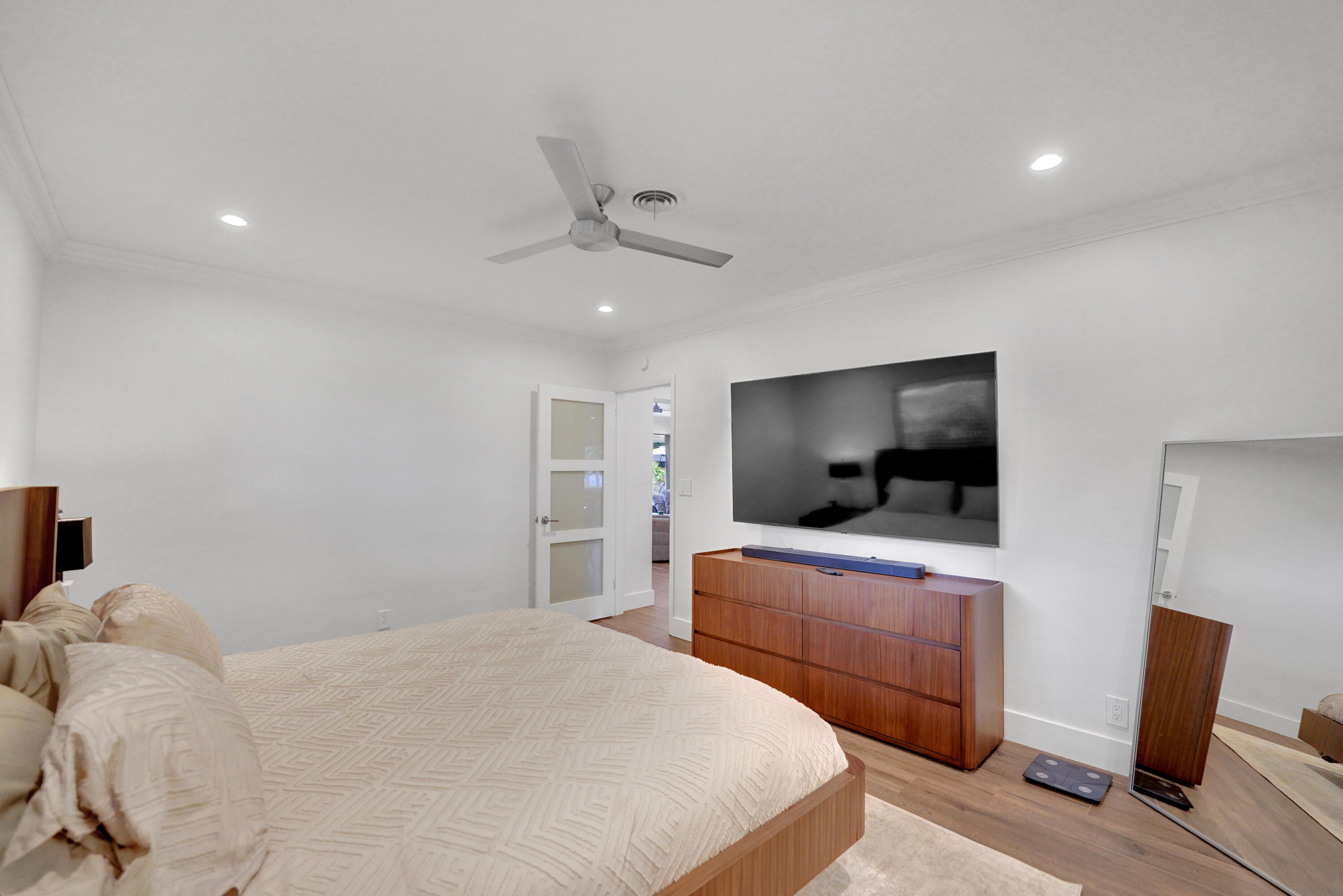 Interior space featuring recessed lighting, a modern ceiling fan, and a three-panel frosted glass door