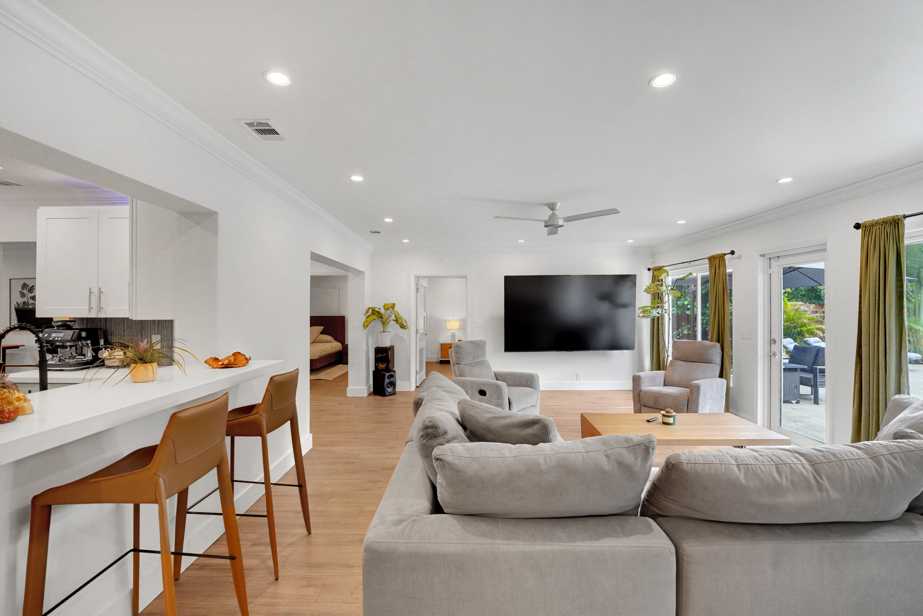 Open-concept living space featuring recessed lighting, a ceiling fan, and double-glass doors